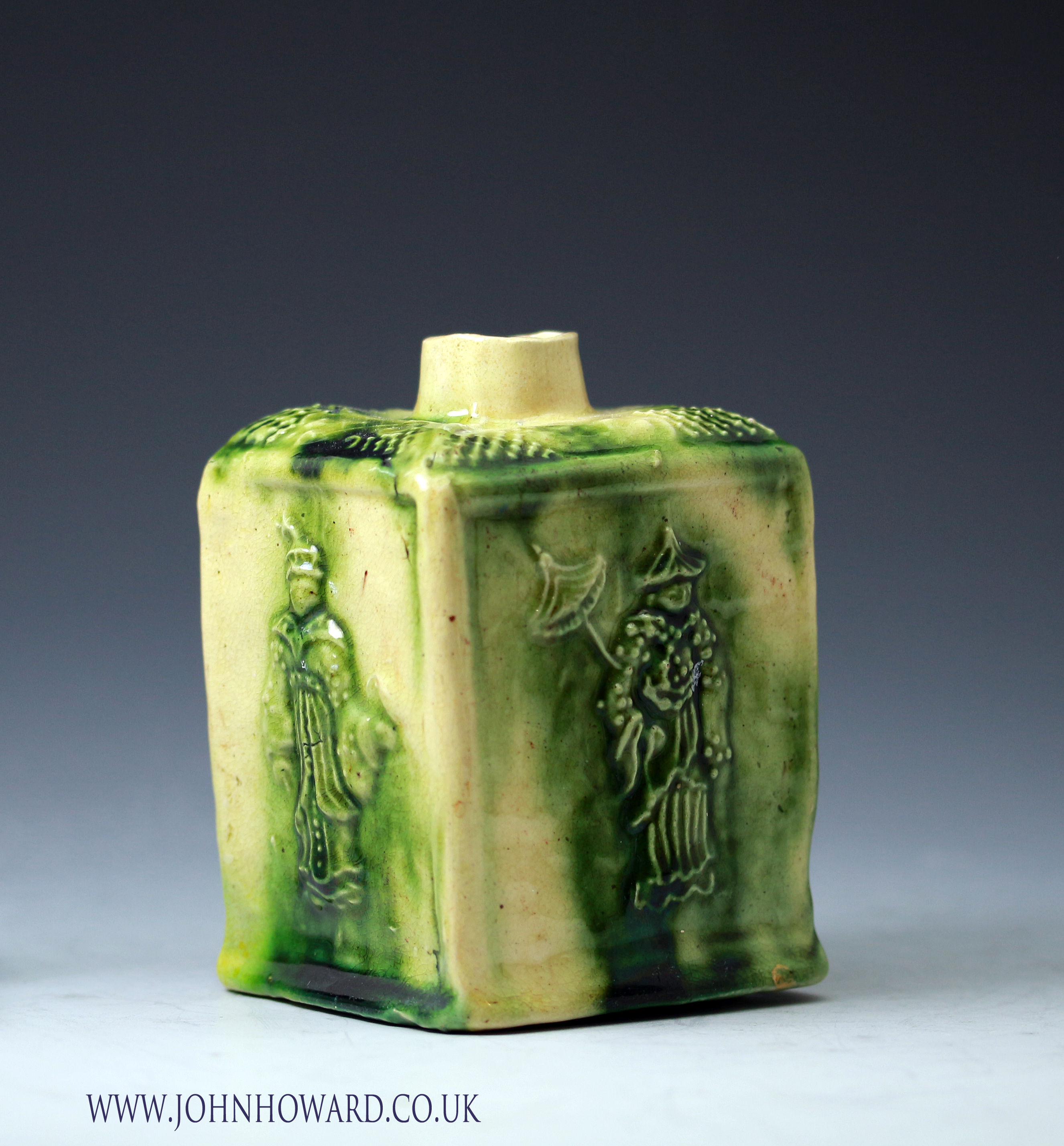 Tea Caddy mid 18th century creamware body with coloured green glaze, relief decorated with Chinese figures. Whieldon type.