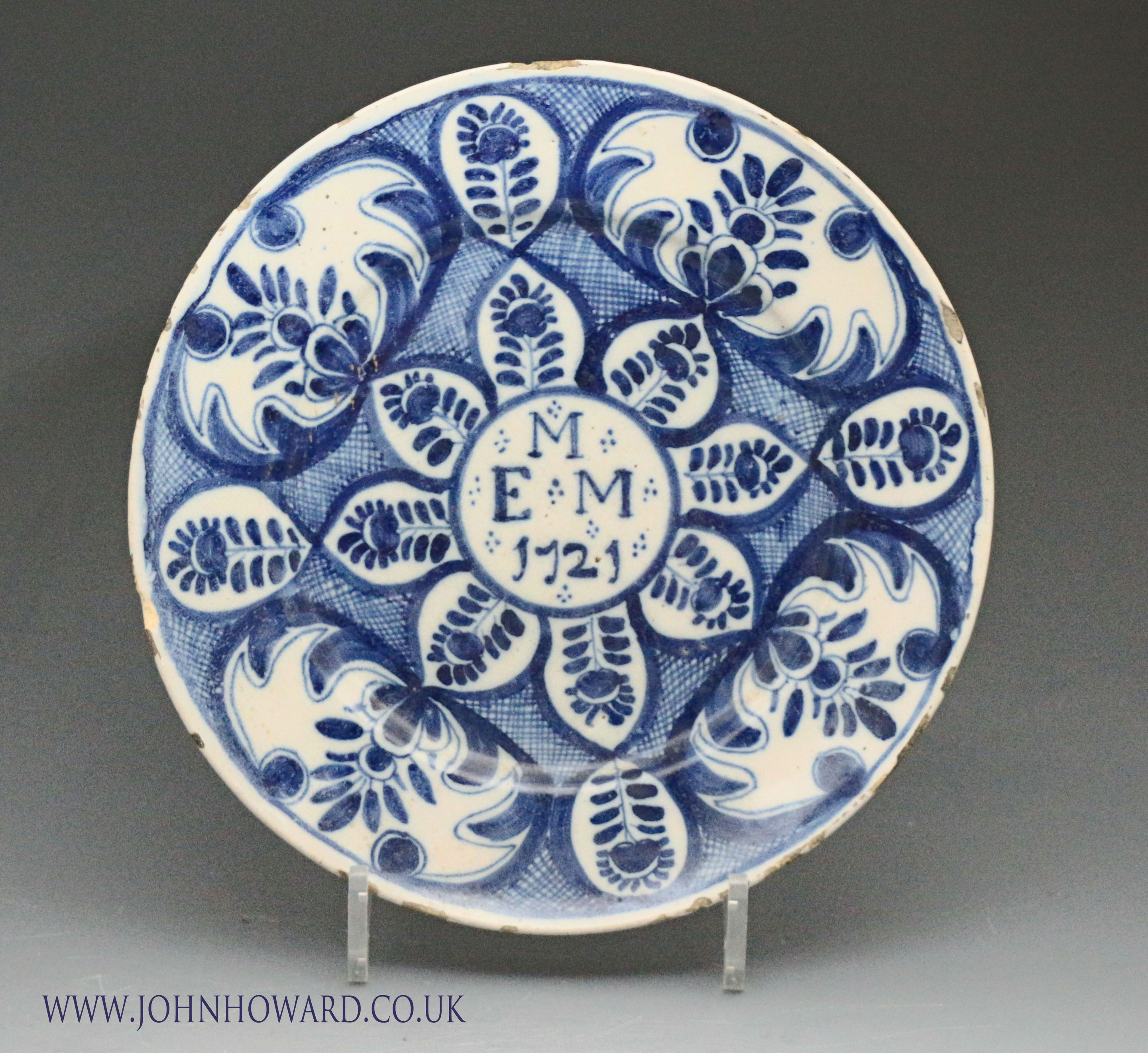 English delftware blue and white plate the central panel with initials M E M and date 1721
