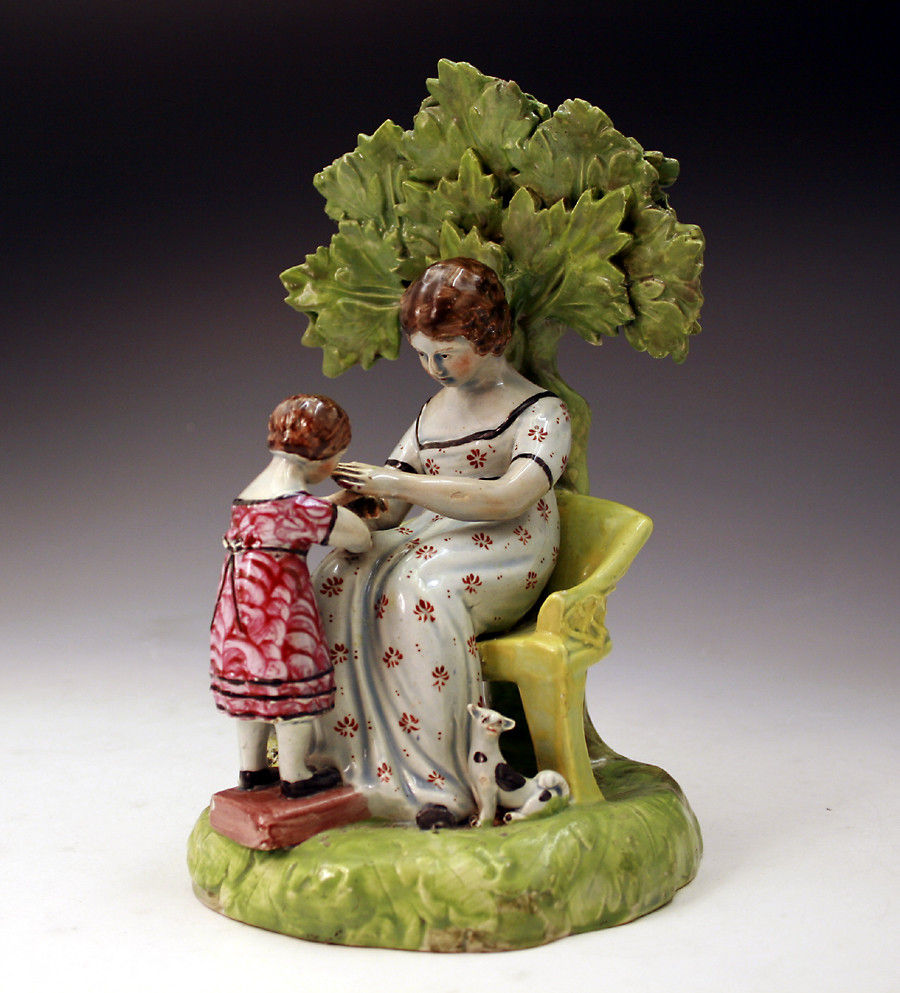 Antique Staffordshire Figure of mother and child at play. c1820