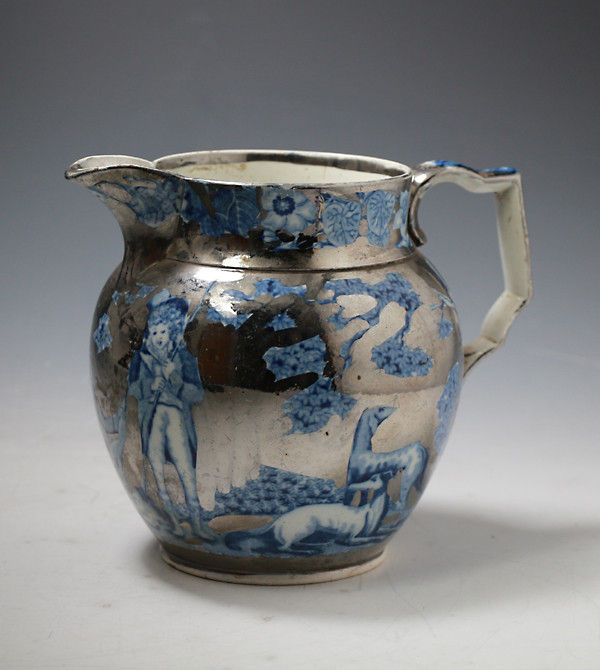 Antique English pottery silver luster pitcher with blue and white transfer.