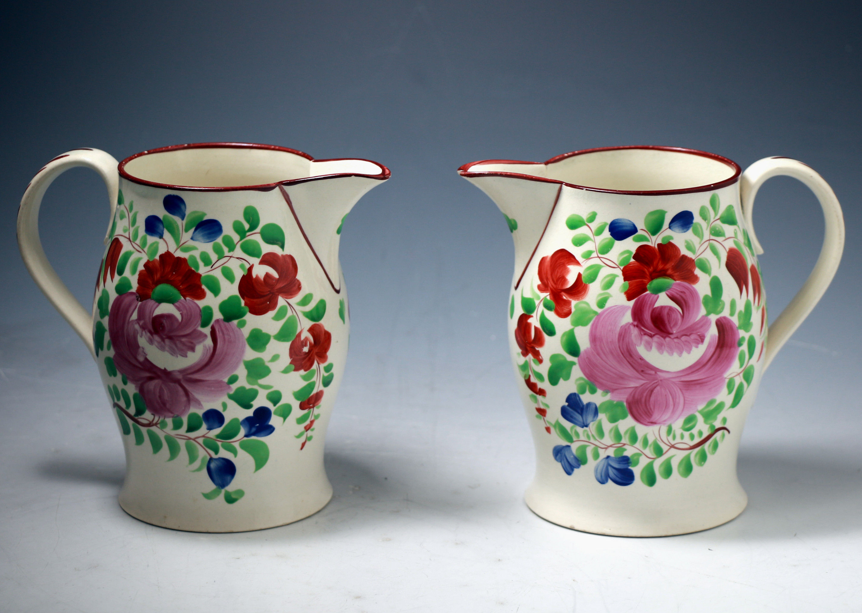 Pair of pitchers with floral decoration attributed to Swansea Pottery Wales