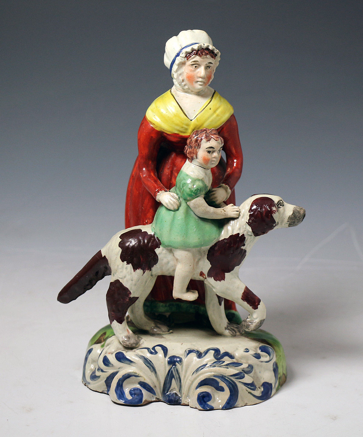 Antique Staffordshire pottery figure of a Nanny with child and dog c1820.