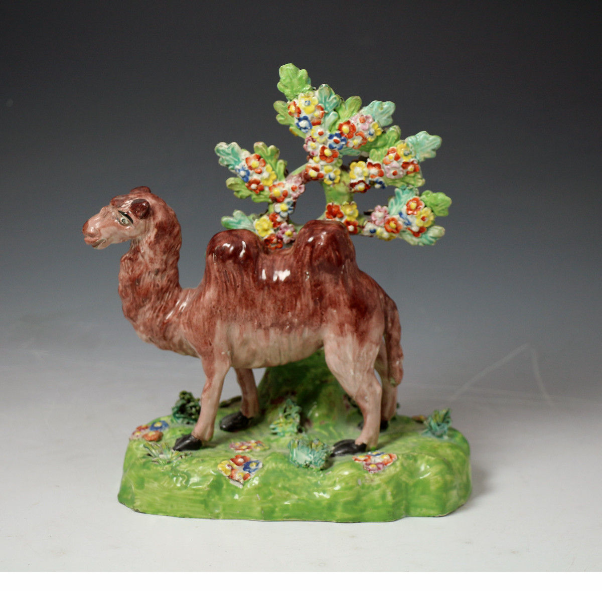 Antique Staffordshire pottery figure of a camel with fine flowered bocage c1815