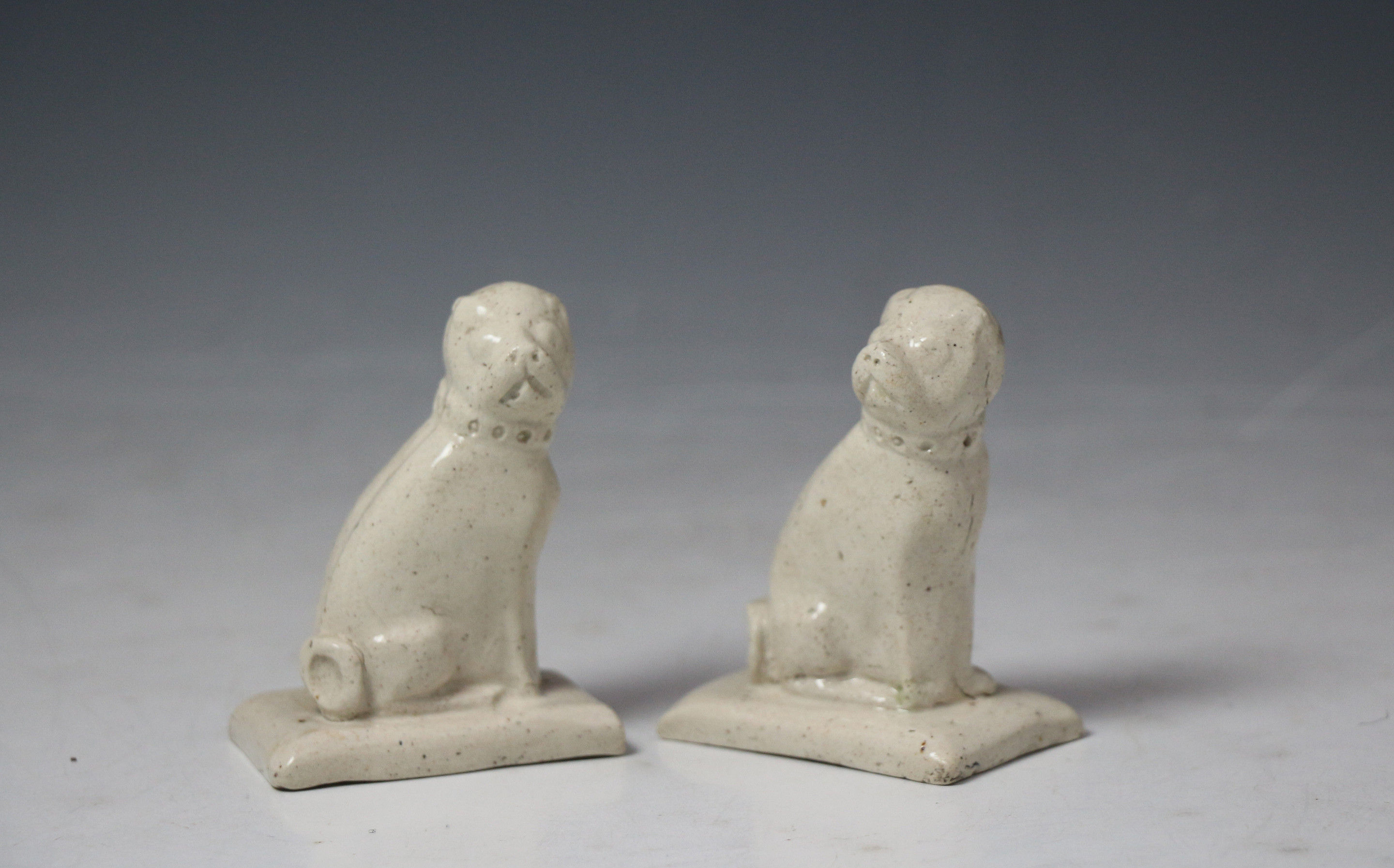 Rare pair of Staffordshire  saltglaze pottery figures of pug dogs c1760