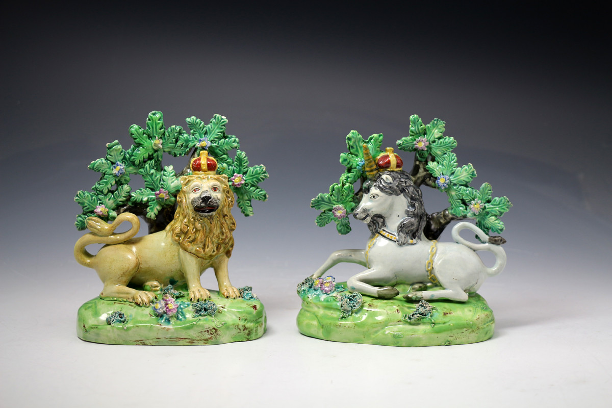 Pair of antique Staffordshire pottery figures of the Lion and Unicorn with bocage by Walton c1820