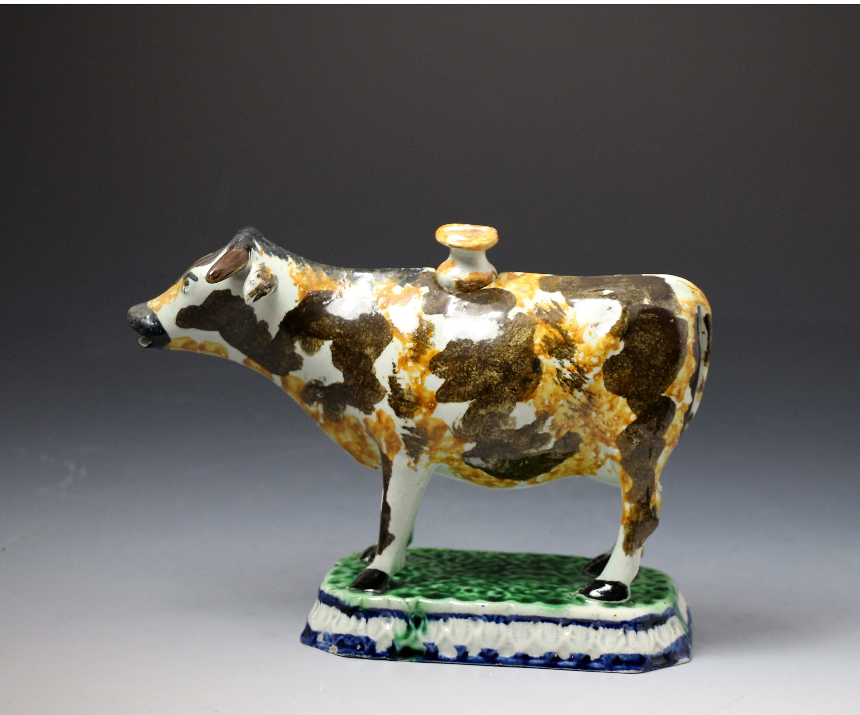 Antique pottery Prattware figure cow creamer, Staffordshire or Yorkshire Pottery. c1810