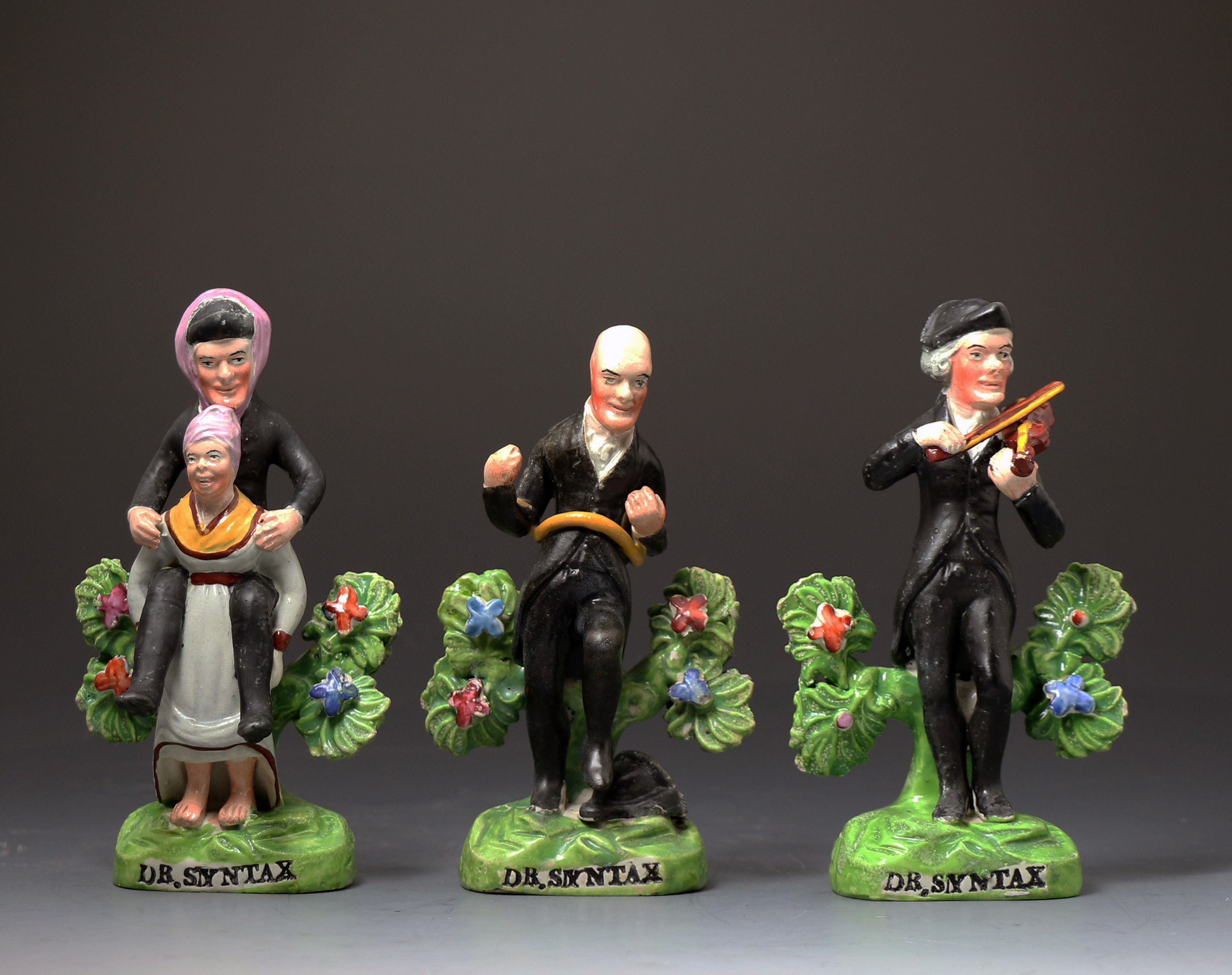  English Staffordshire pottery pearlware bocage figures of  Doctor Syntax the cartoon character.Early 19th century period.      