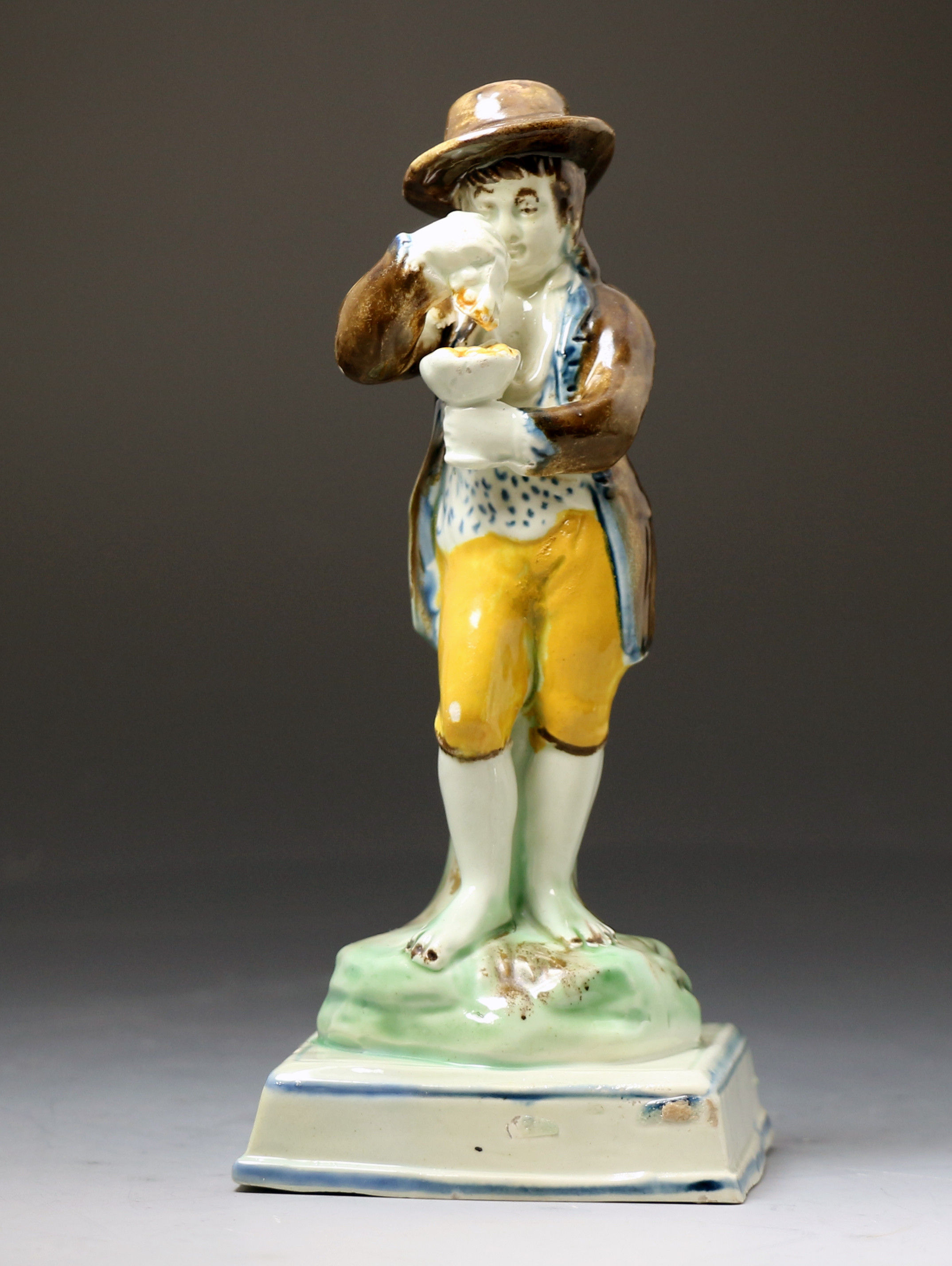 Prattware figure of a boy on square base English pottery c1810 probably Staffordshire