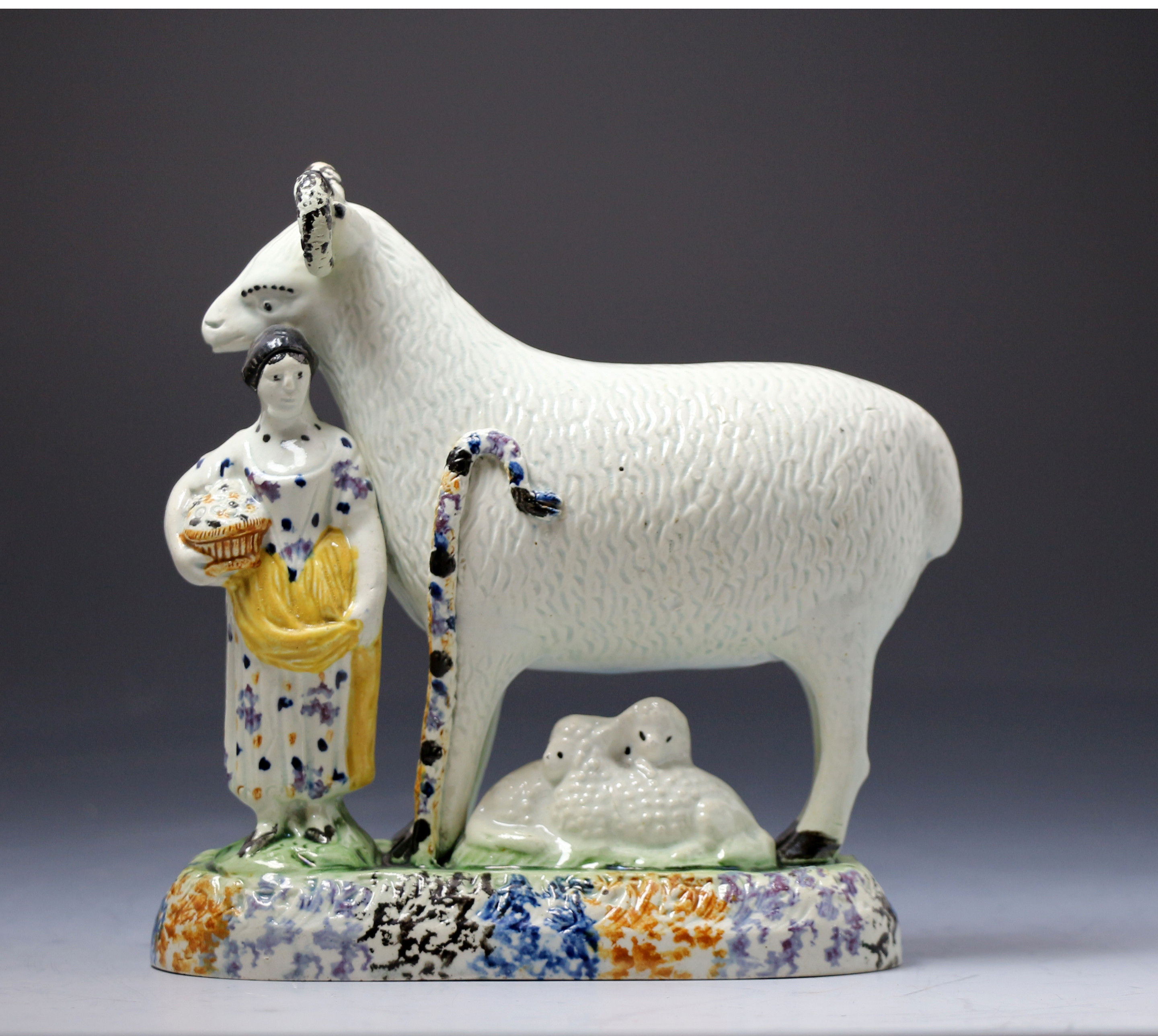 Antique period Yorkshire pottery figure of a ram with female attendent in Pratt colors.