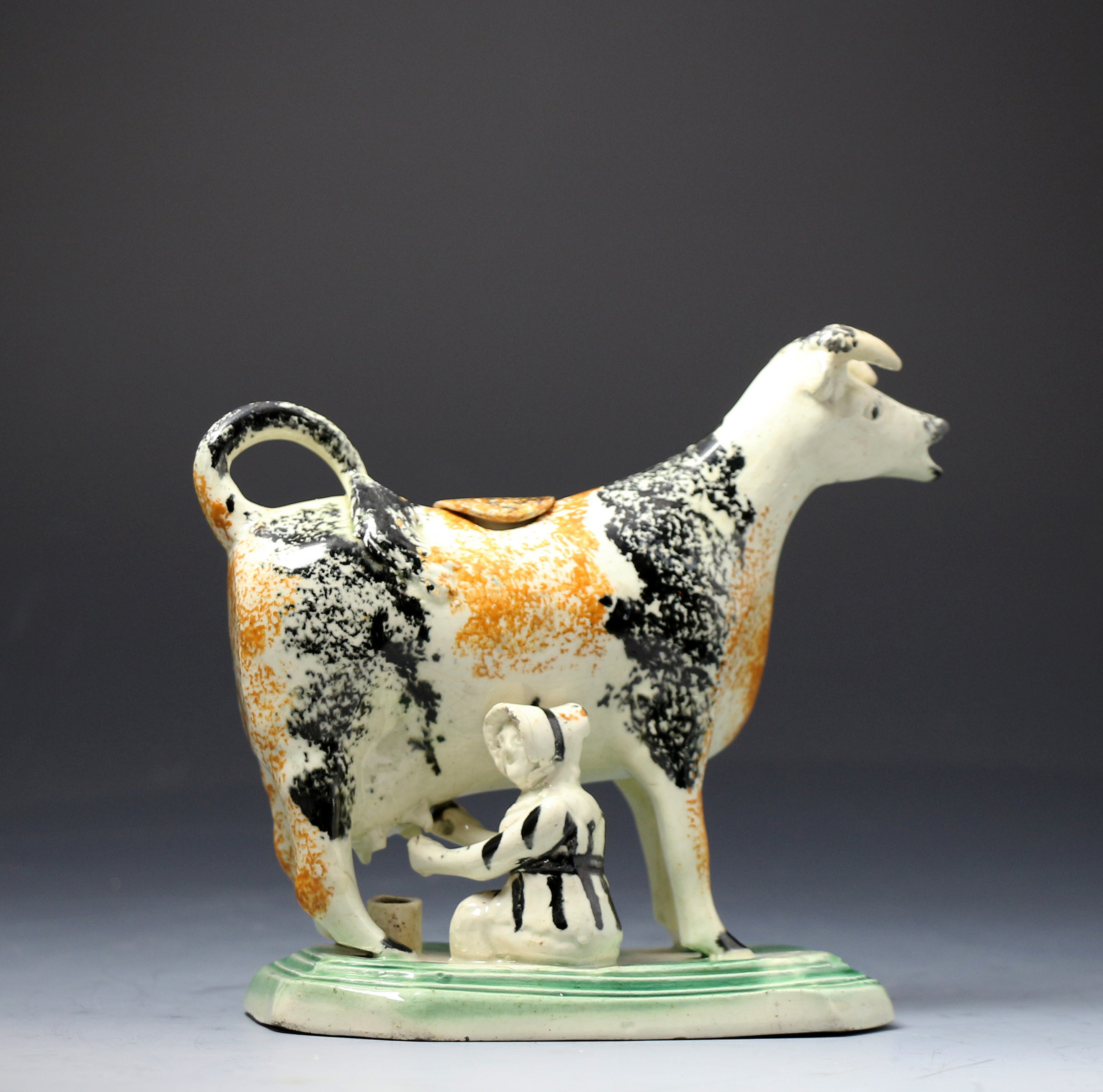 Antique English pottery figure of a cow in the form pof a creamer probably Yorkshire Pottery