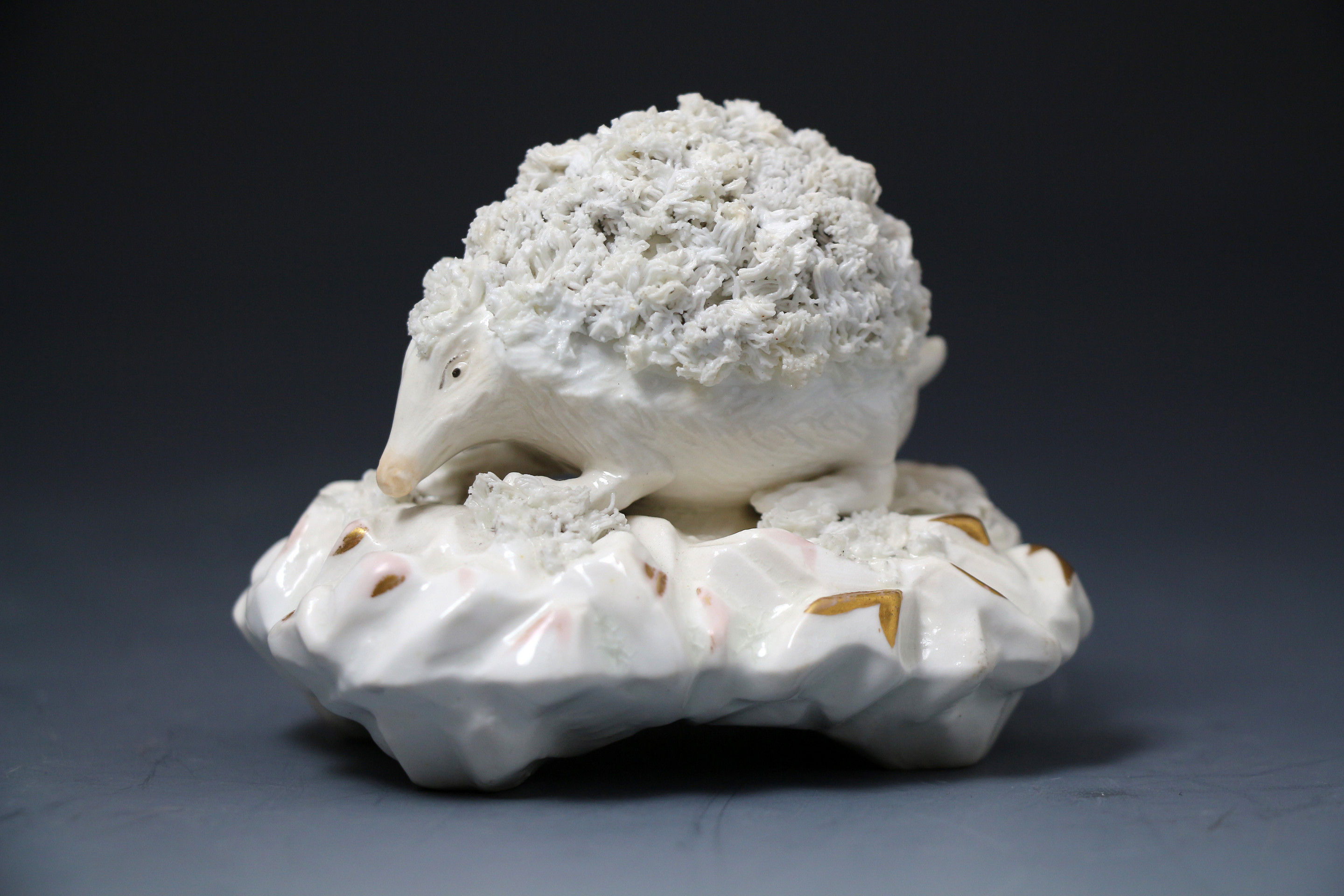 Antique Staffordshire  English porcelain figure of a hedgehog on gilded base early 19th century period.