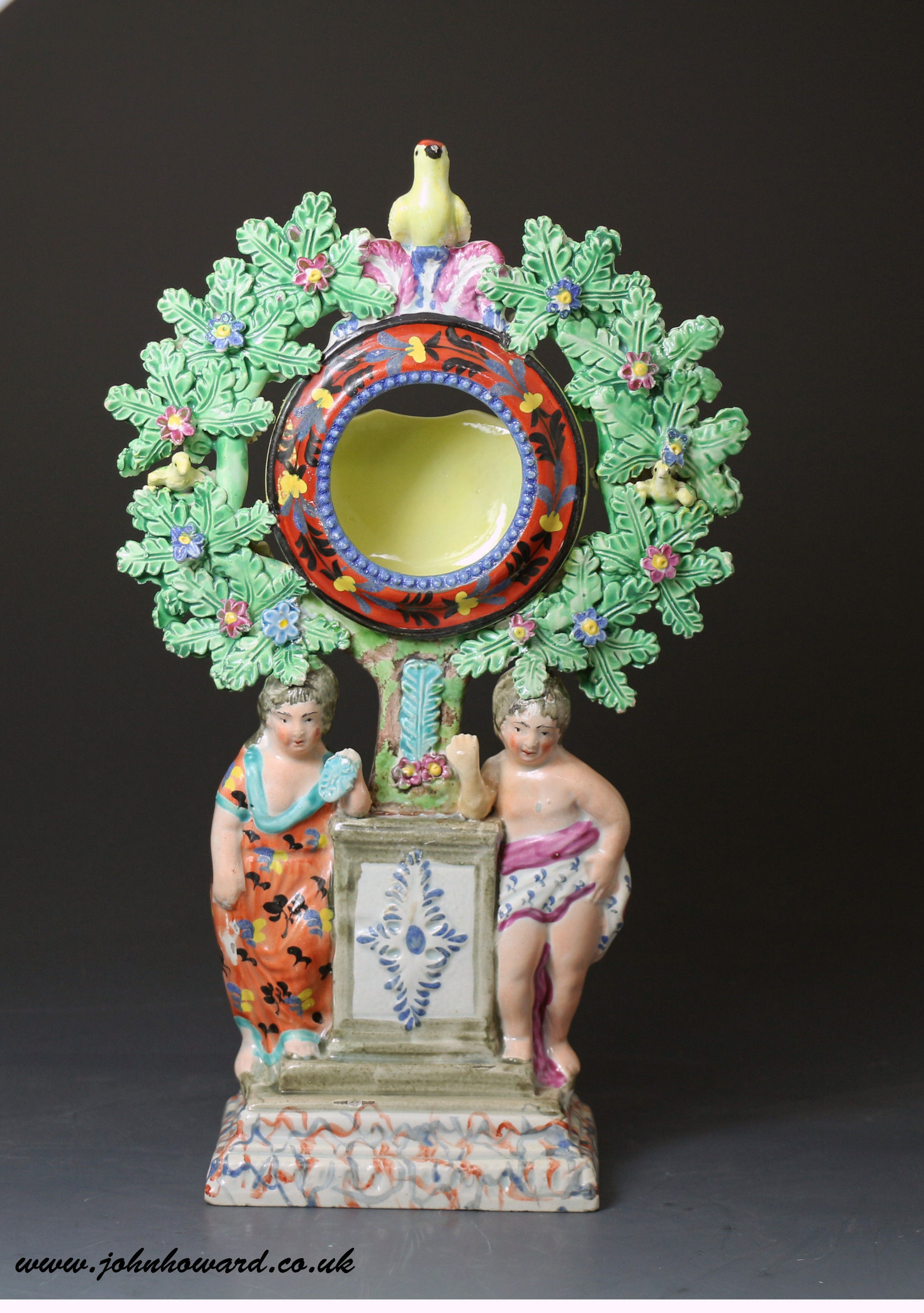 Antique Staffordshire pottery pearlware bocage watch holder with figures of children and birds perched in the bocage