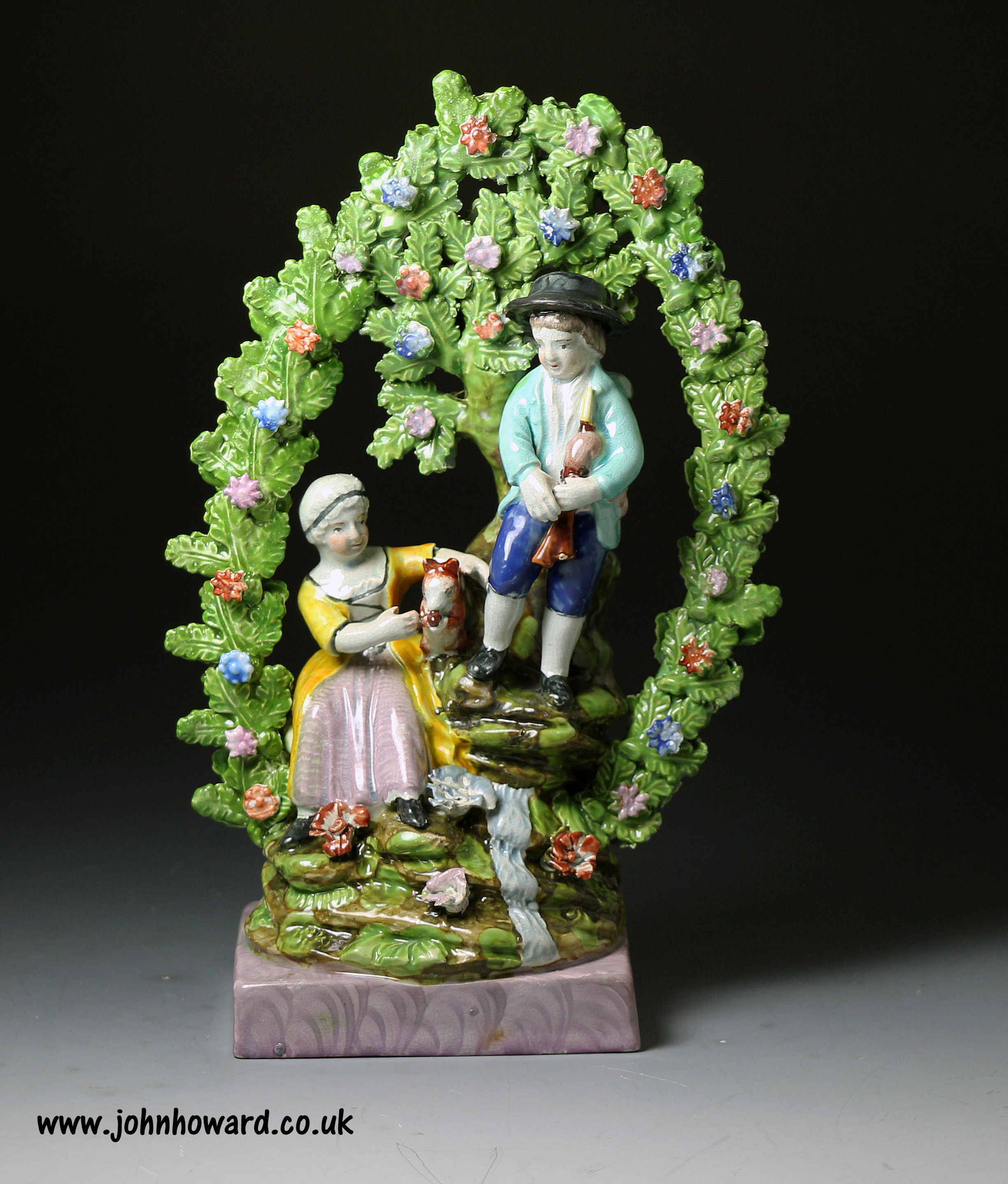 Antique Staffordshire pottery pearlware figure of the Rural Pastimes with hoop shaped bocage circa 1820 period