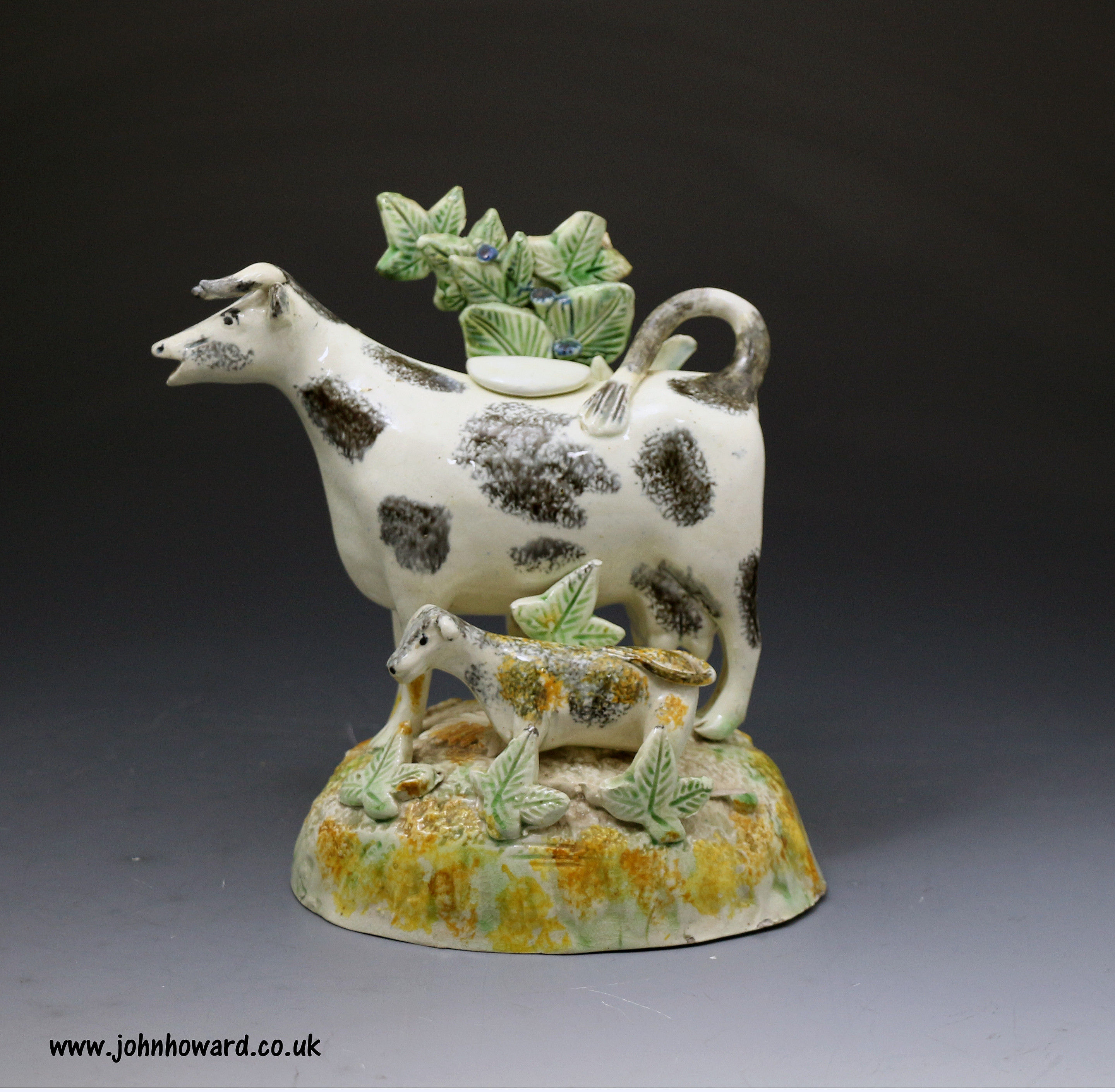 Antique English pottery cow creamer with bocage late 18thcentury