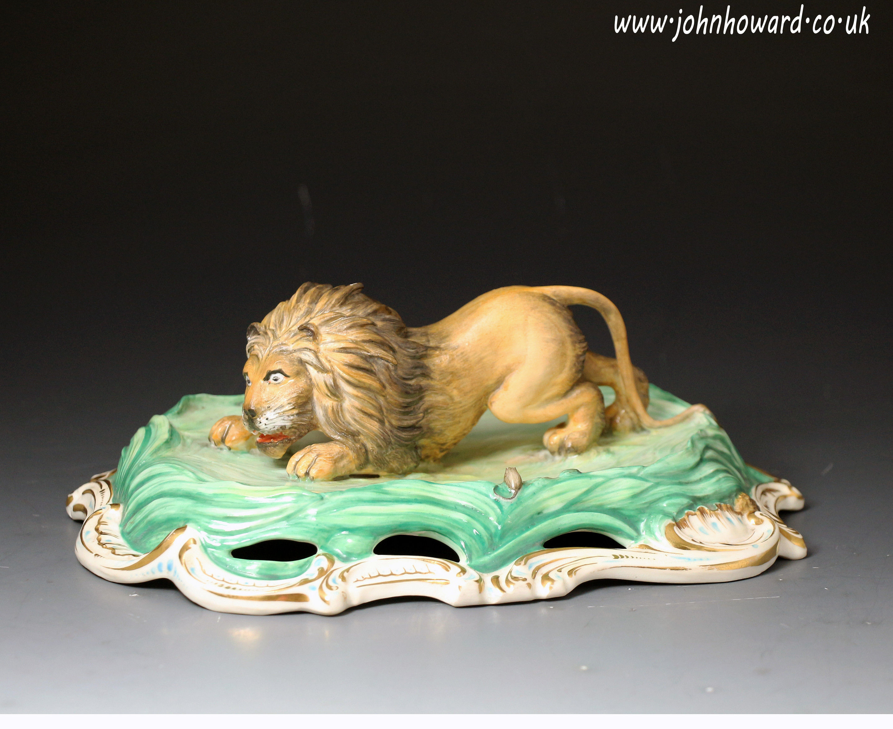Antique English porcelain figure of a crouching lion