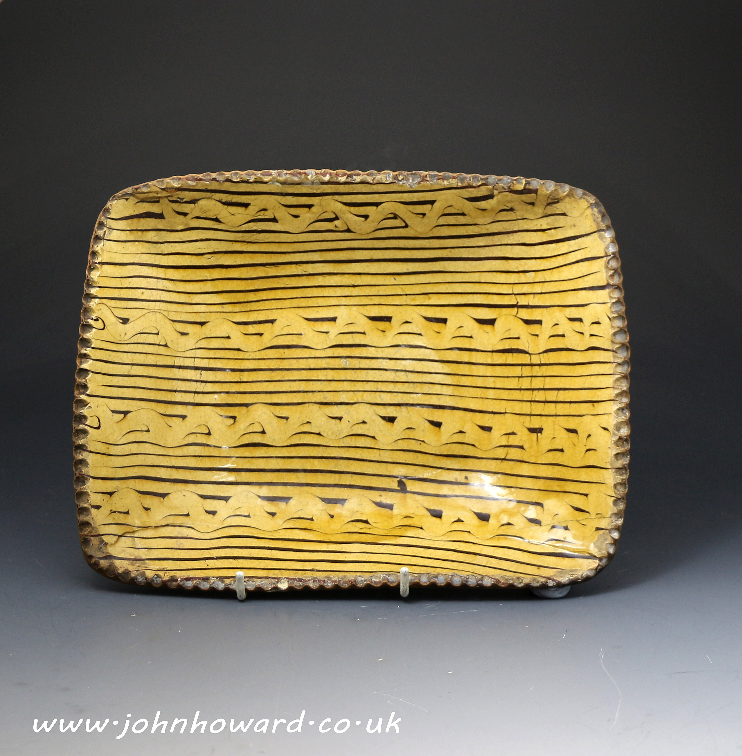 A fine antique period slipware earthenware loaf dish with squiggle  decorations to slip 18th century England