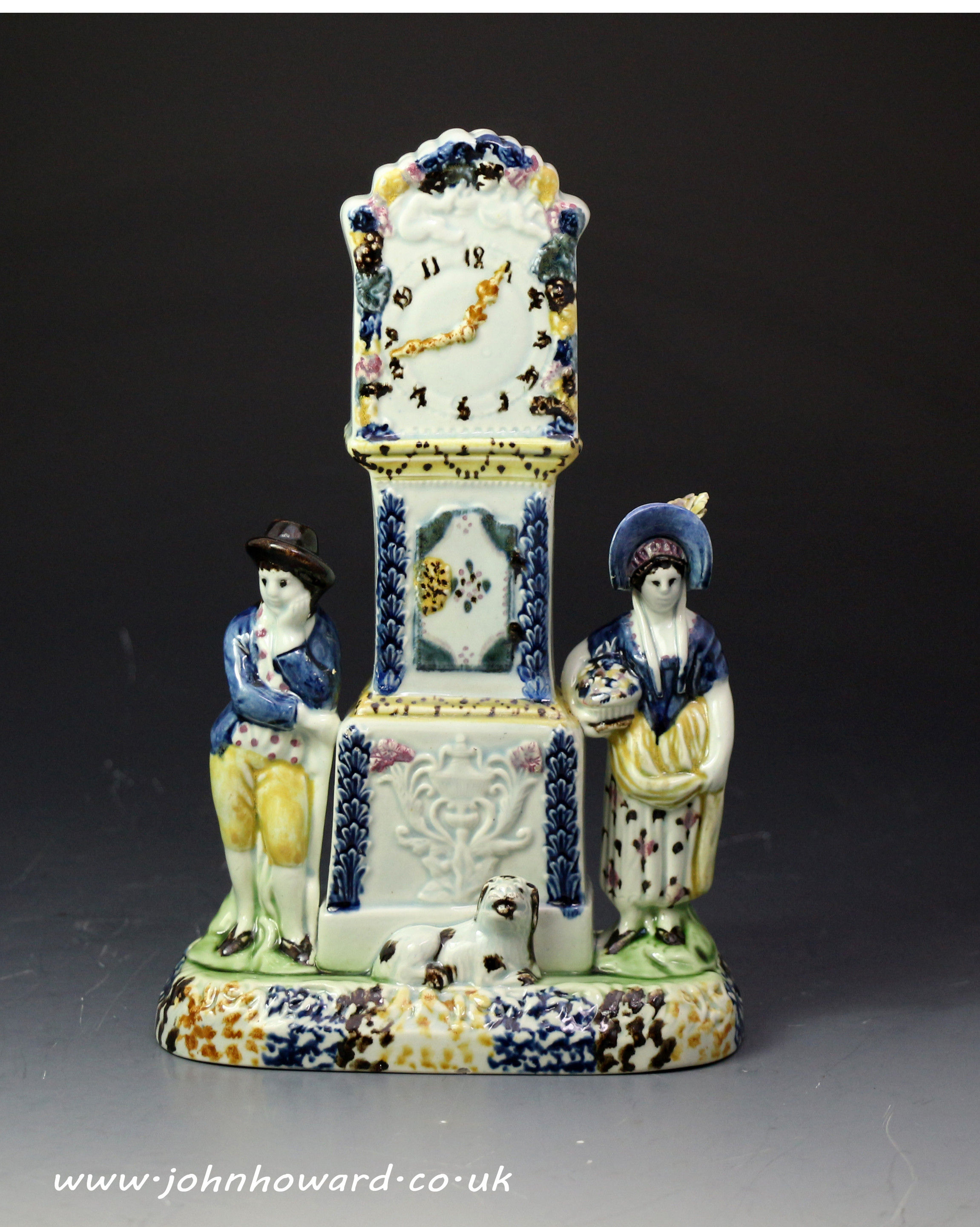 Antique pottery prattware clock group with figures in the form  of a money bank. Yorkshire 1810