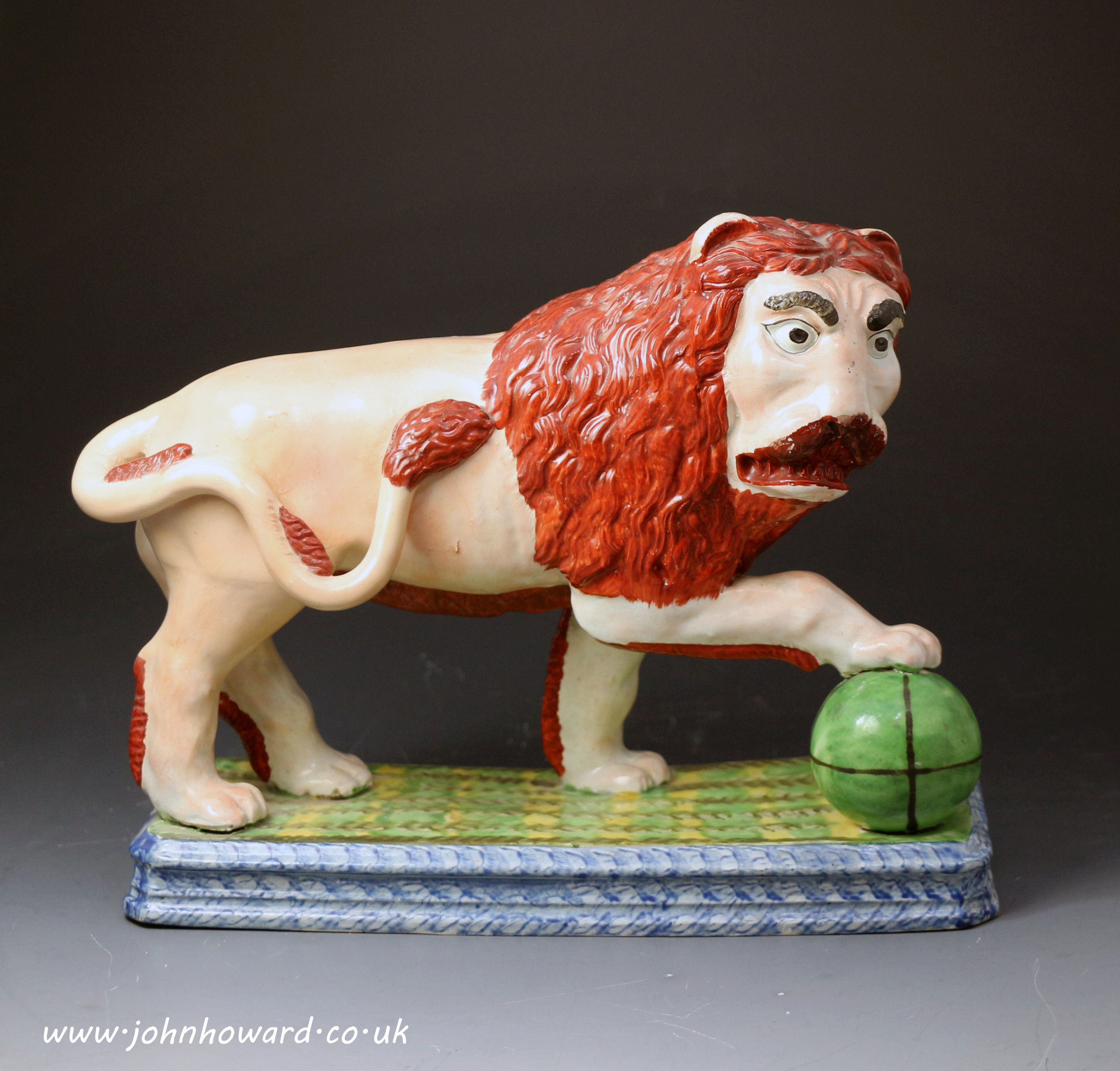 Antique Staffordshire pottery figure of a standing Lion. c1820