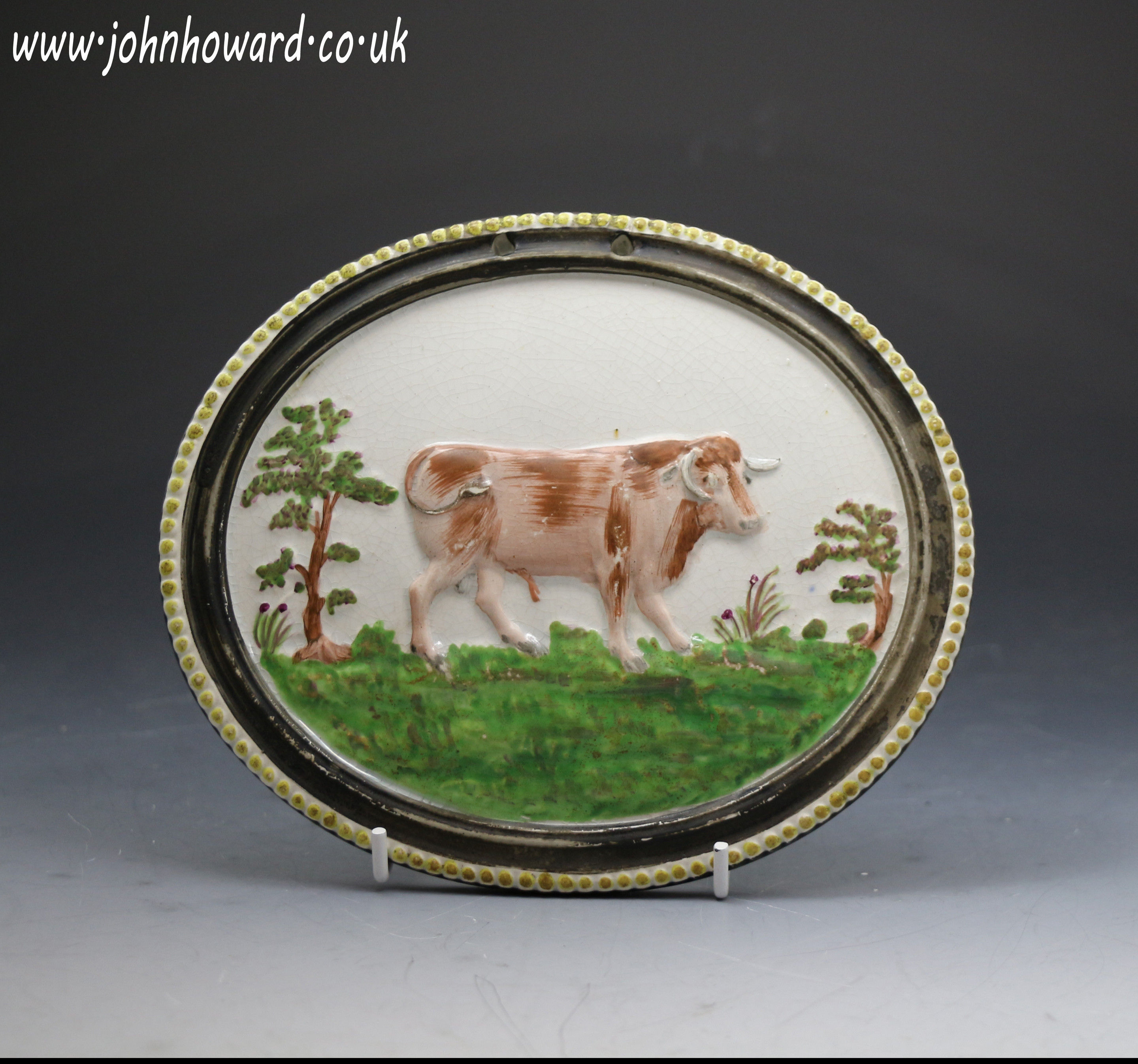 Antique Staffordshire pottery oval plaque with figure of a bull , pearlware galze and enamel colours c1820