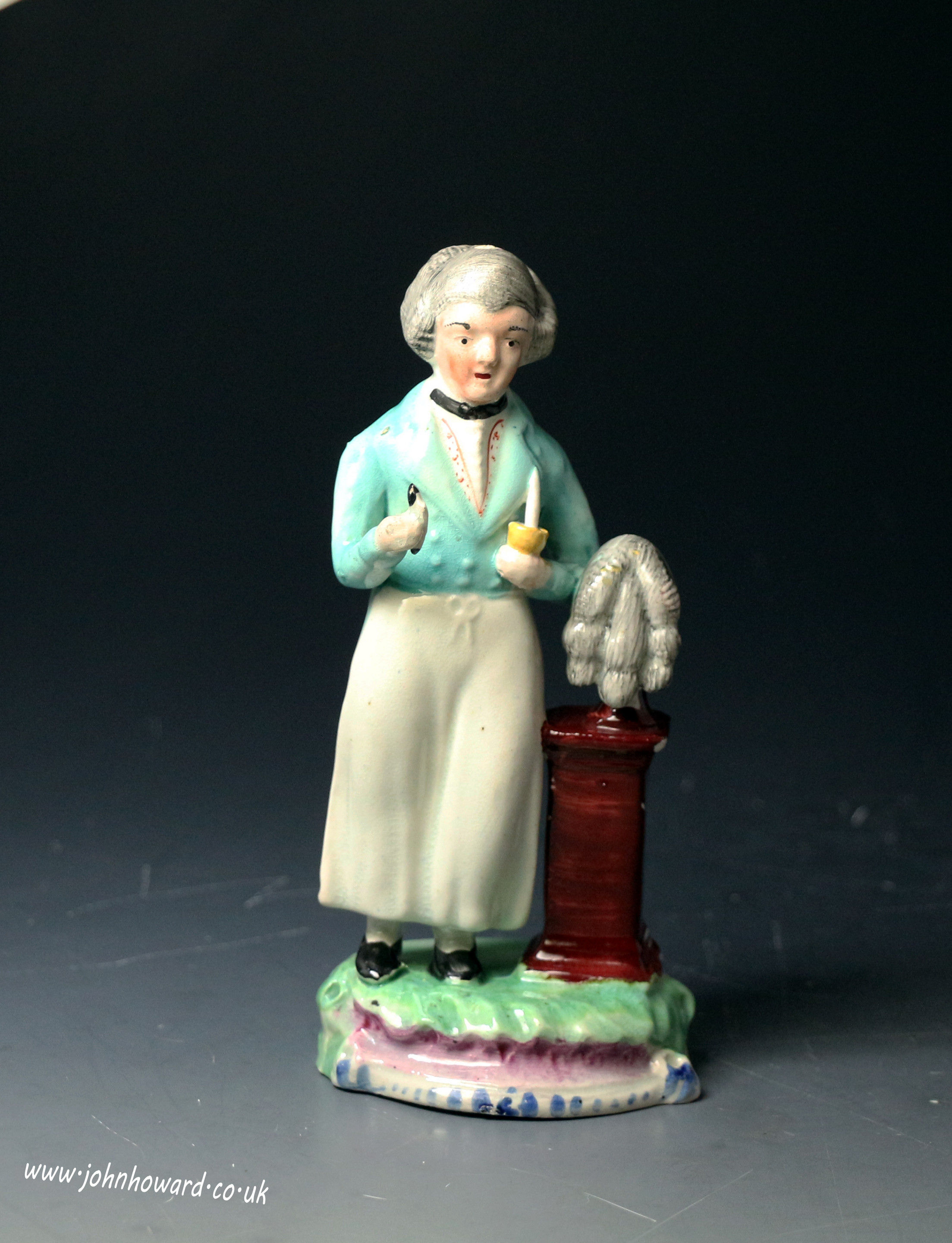 Antique English Staffordshire pearlware pottery figure of a wig maker early 19th century period.