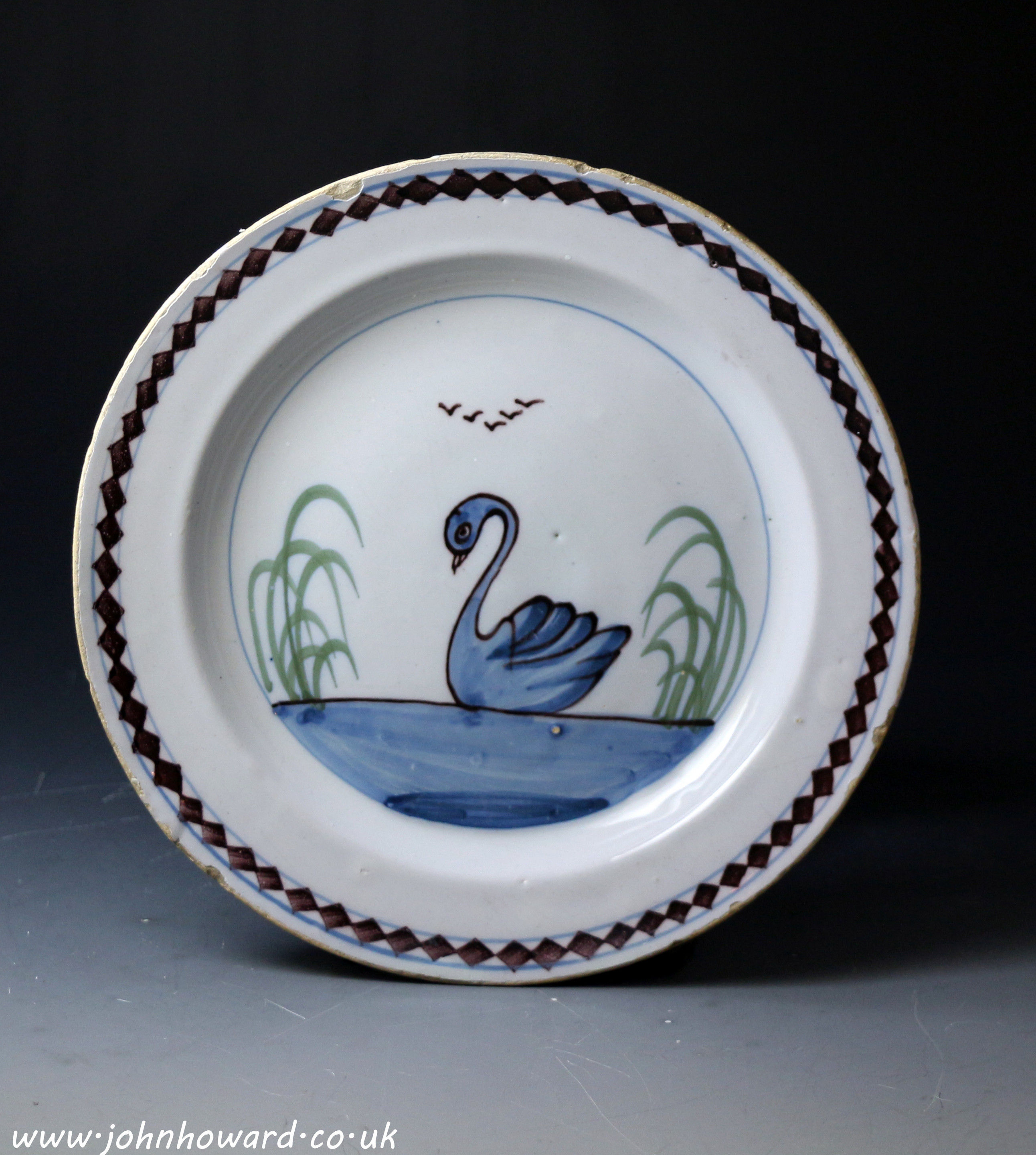 Antique English delftware plate with image of  a swimming swan 18th century