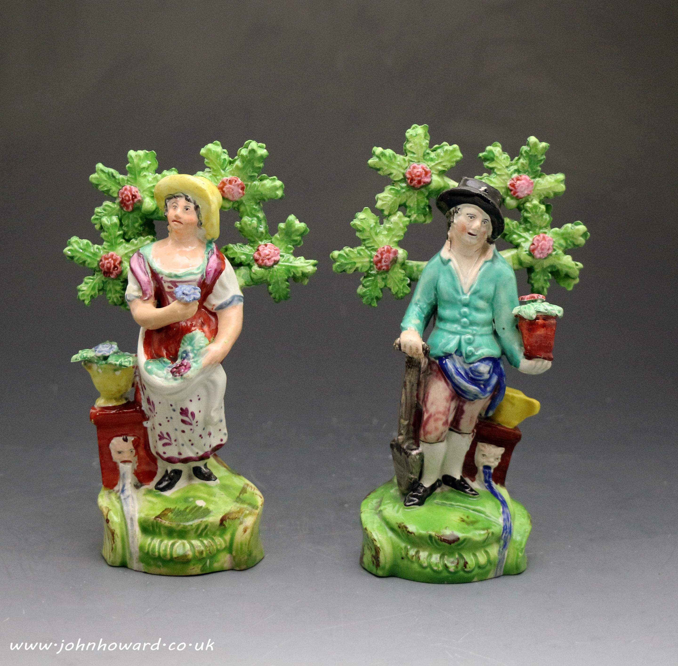 Antique Staffordshire figures of a male and female gardeners early 19th century.