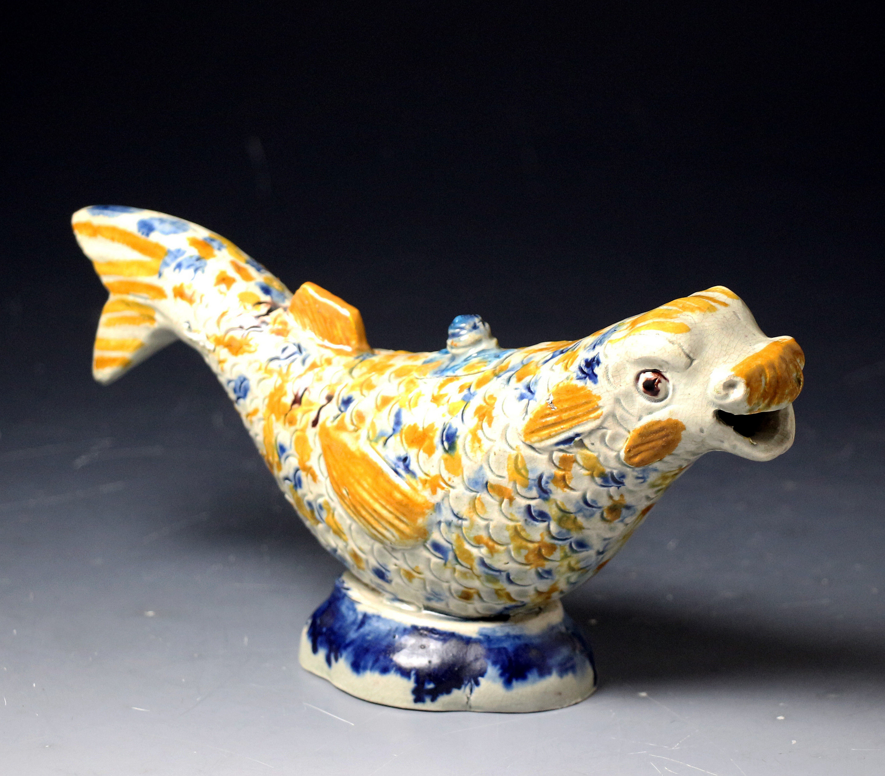 Antique English pottery prattware figure of a dolphin formed as a creamer/sauce boat with cover.