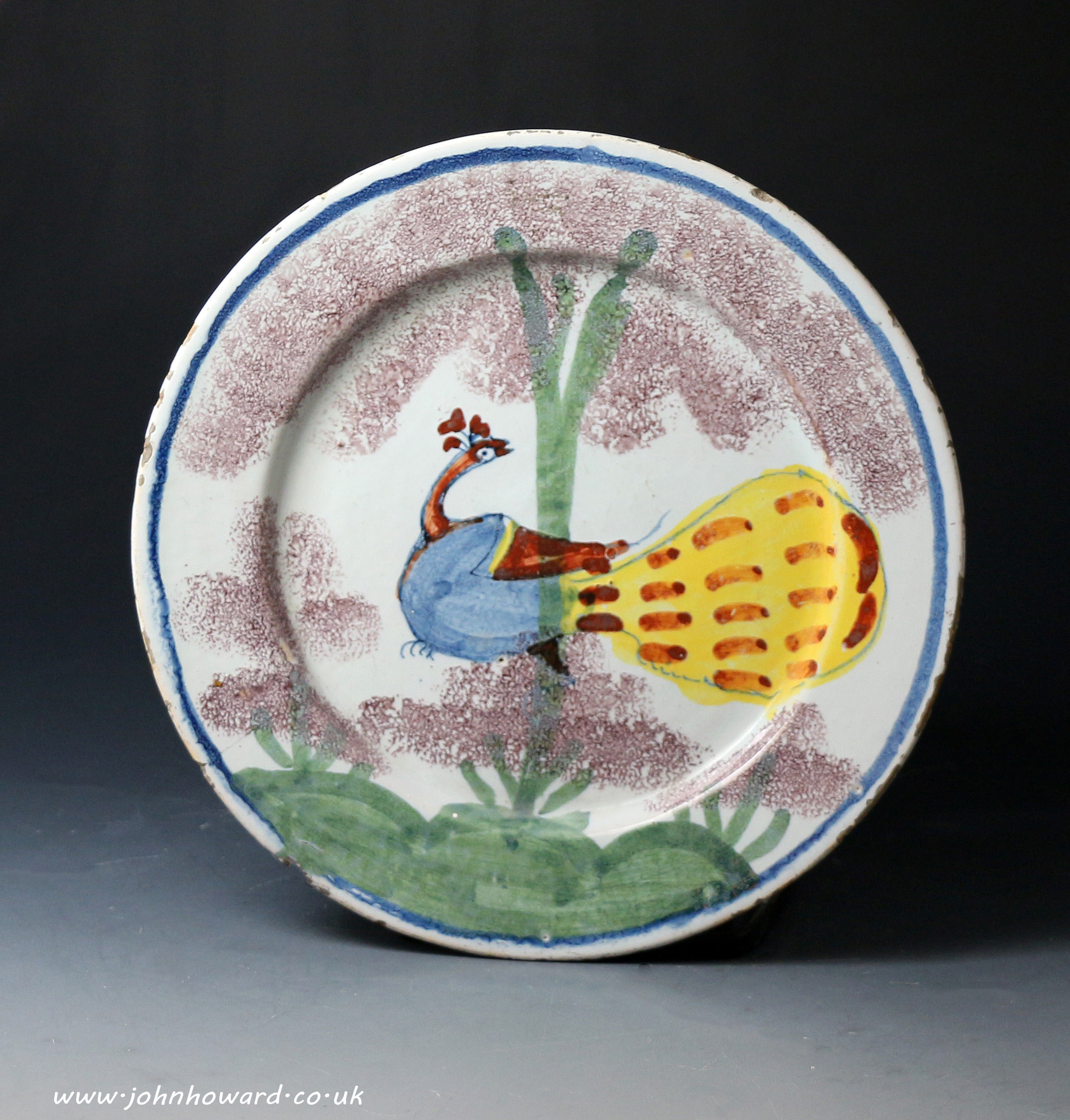 Bristol Pottery delftware plate decorated in polychrome  with peacock in a tree.Antique period early 18th century