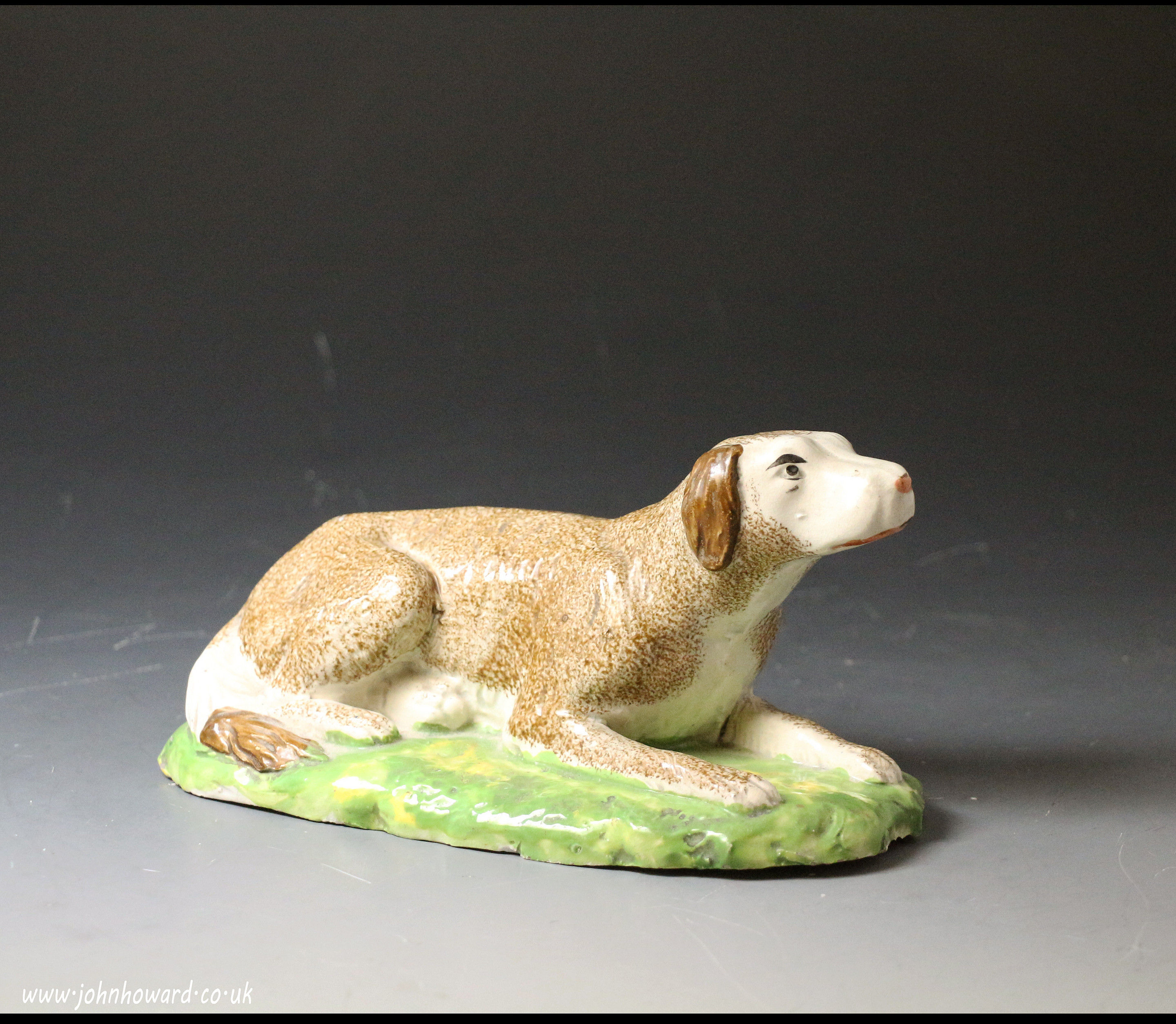 Antique Staffordshire pottery figure of setter in pearlware and enamel colours. Early 19th century