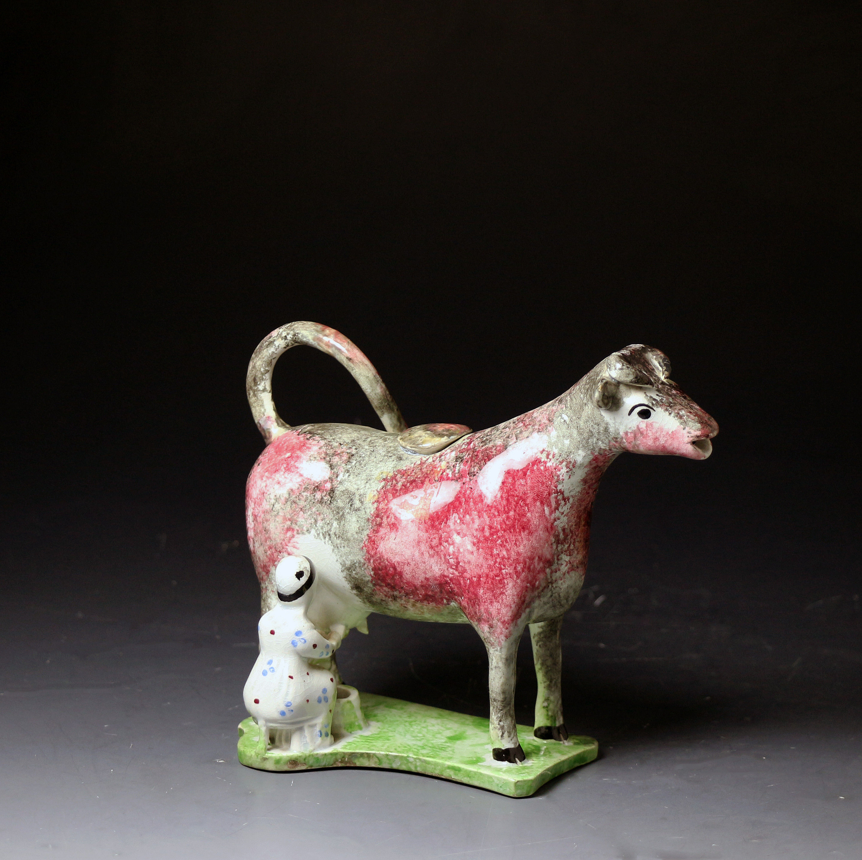 Antique English pottery figure in  the form of a cow creamer circa 1810 period.
