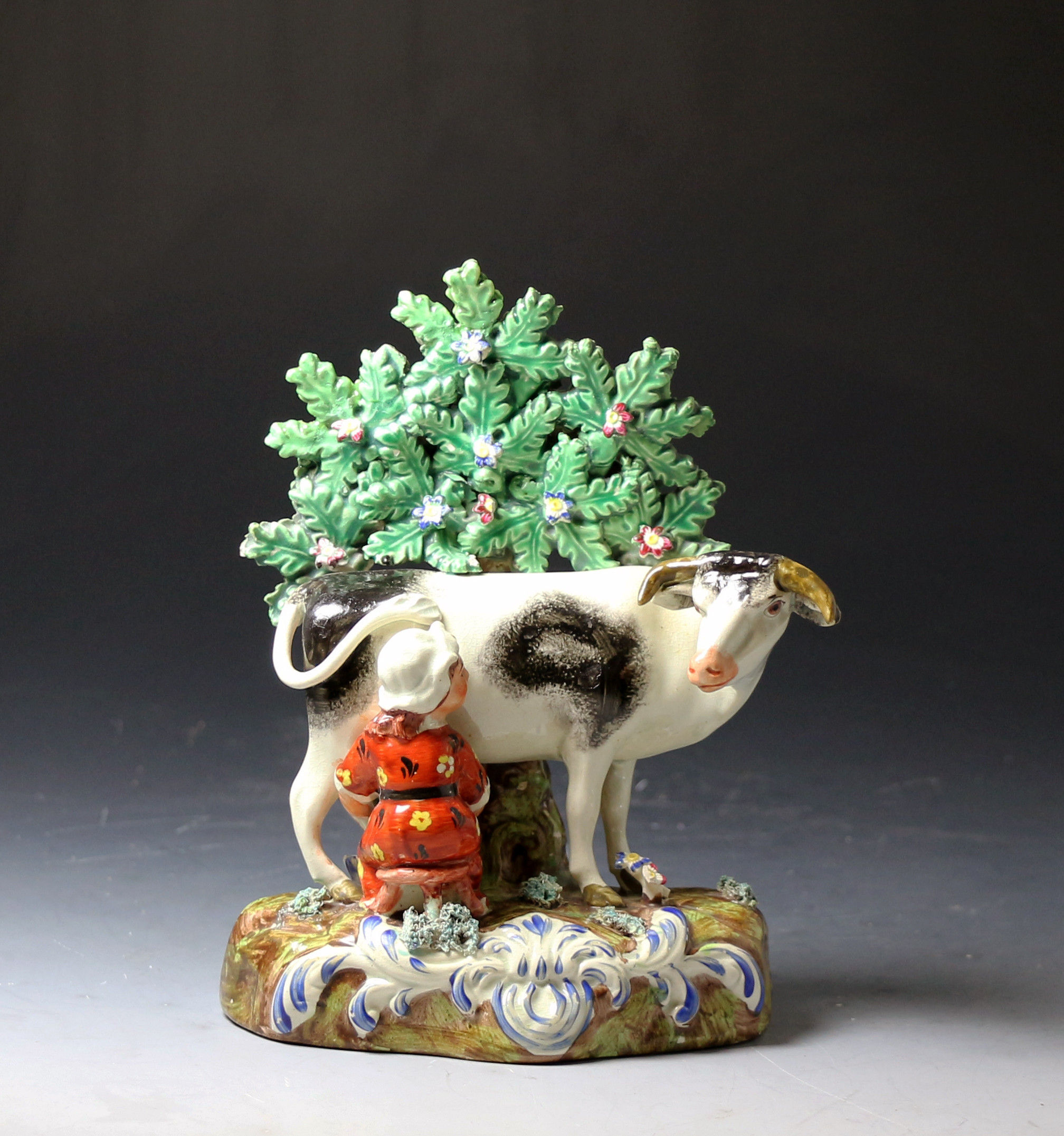 Antique Staffordshire pottery pearlware figure group of cow and milkmaid with bocage early 19th century