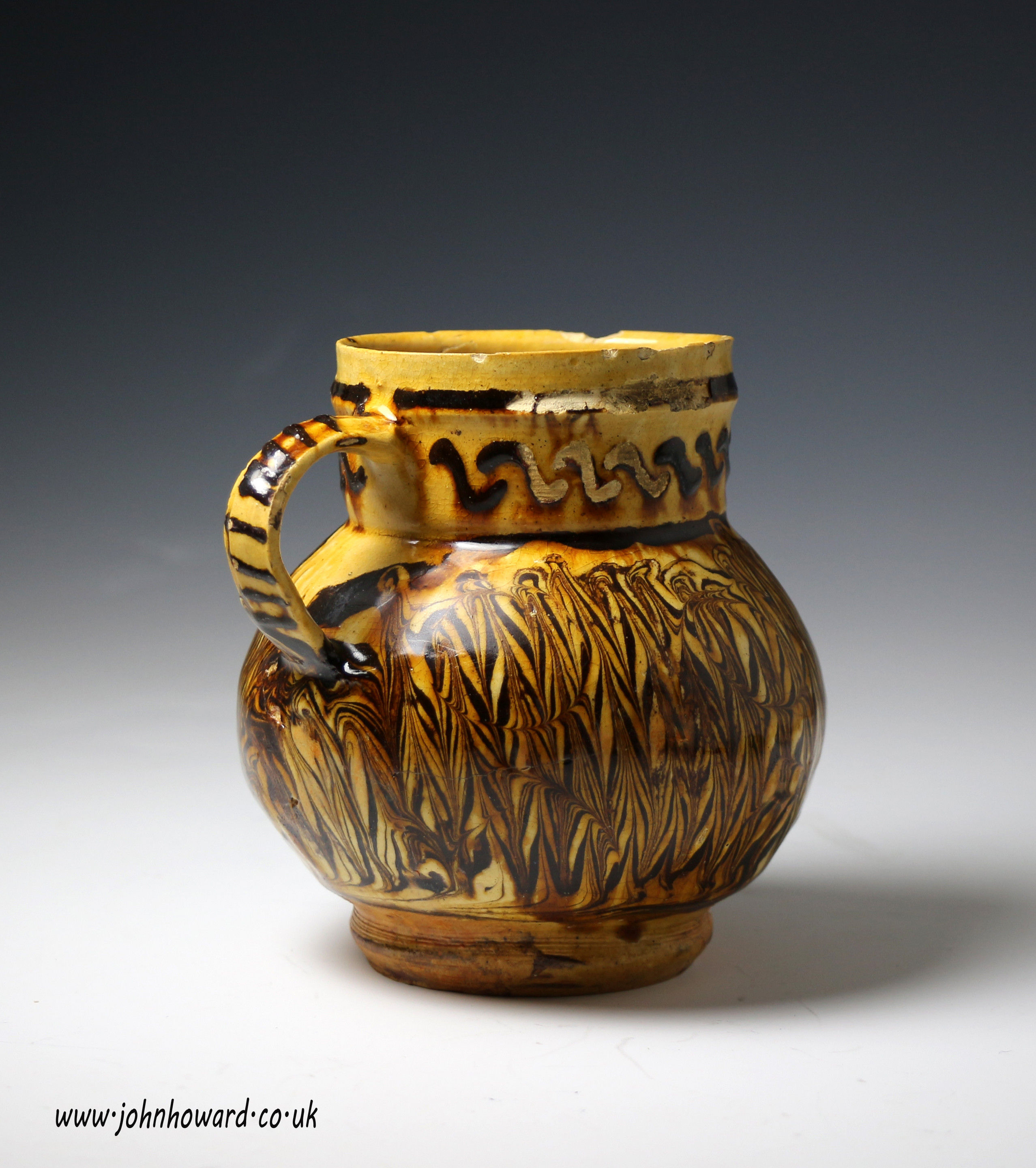 Early English earthenware slip decorated tankard circa 1650