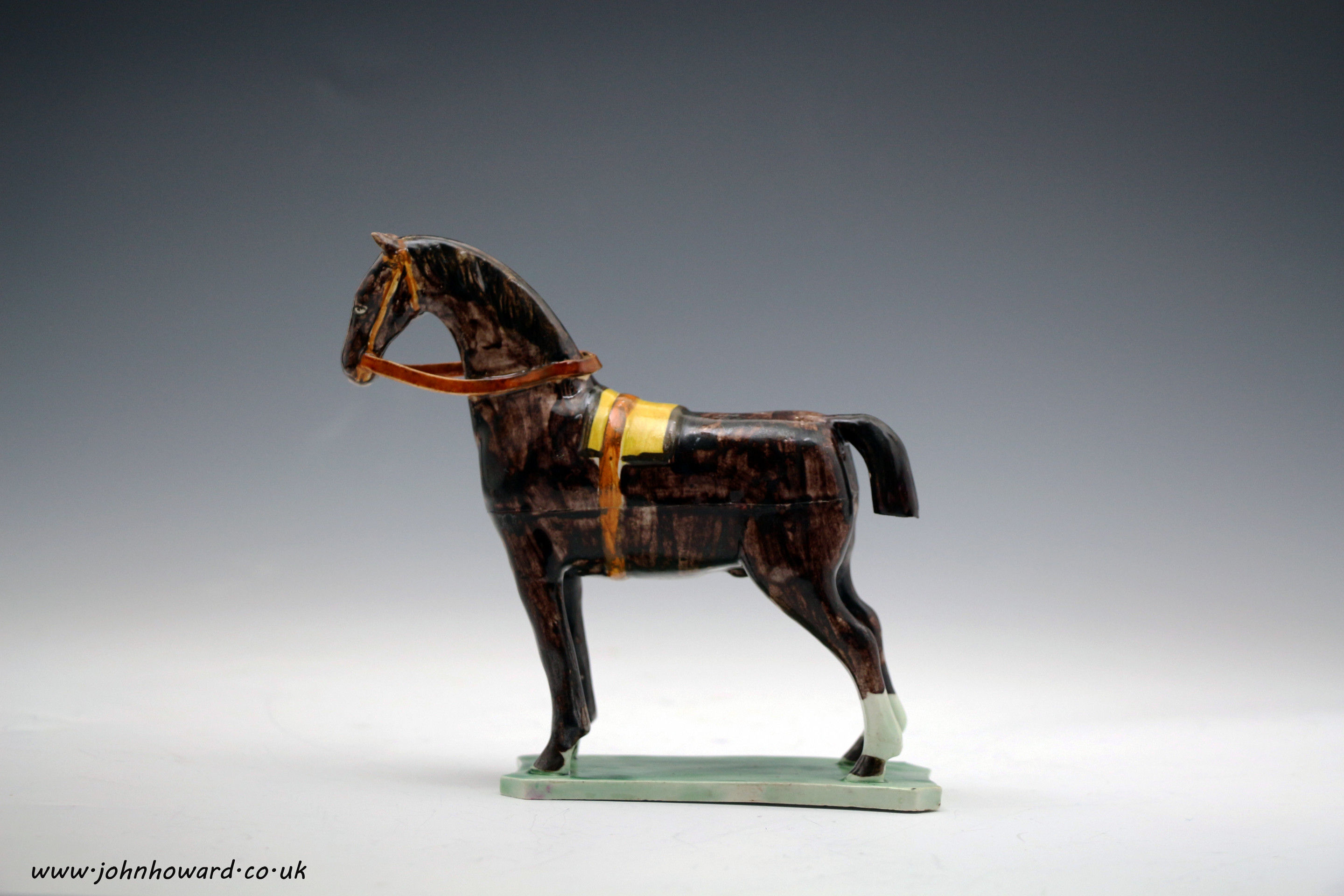 Antique English pottery figure of a horse on green base North East England c1790