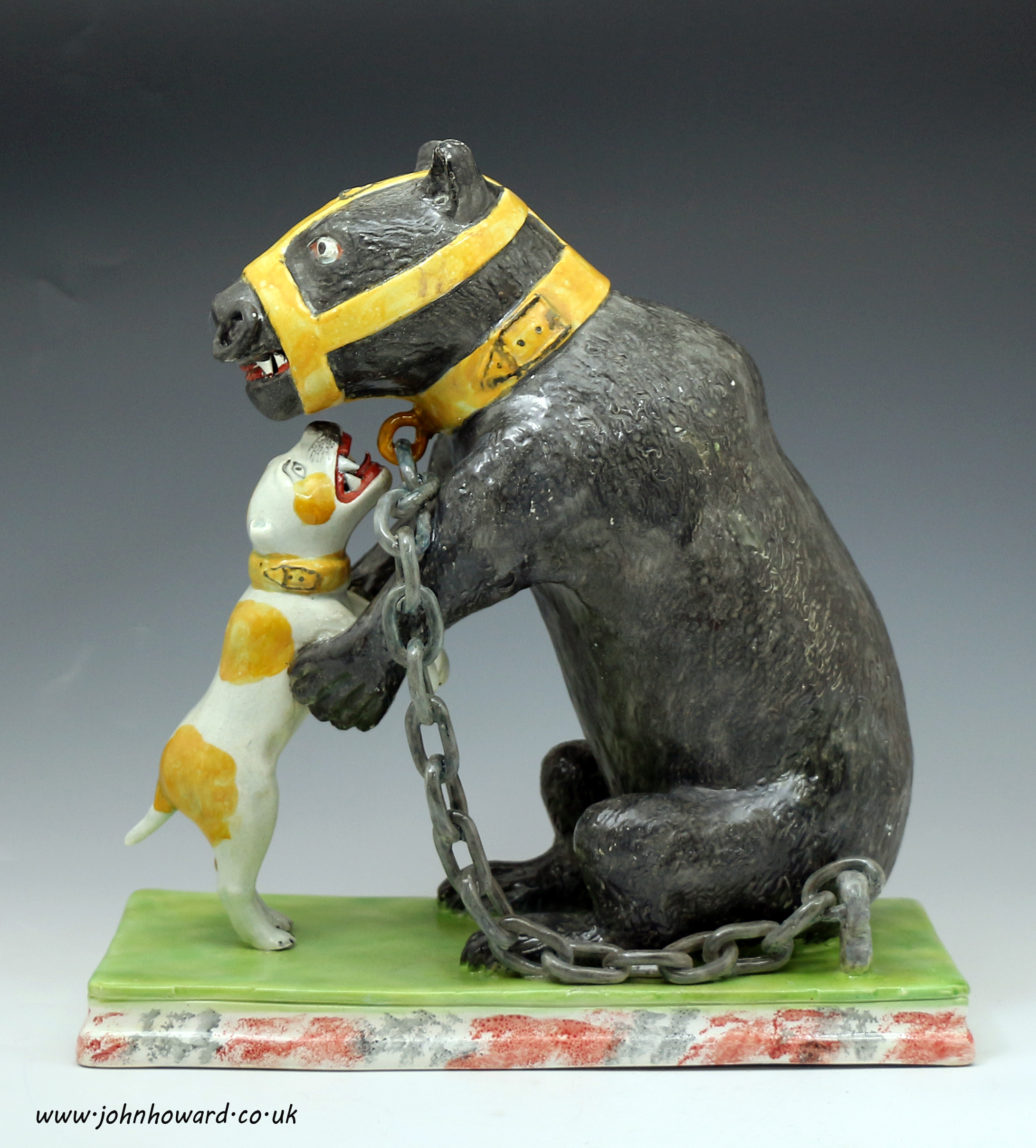 Staffordshire pottery figure of a bear baiting in pearlware early 19th century English.