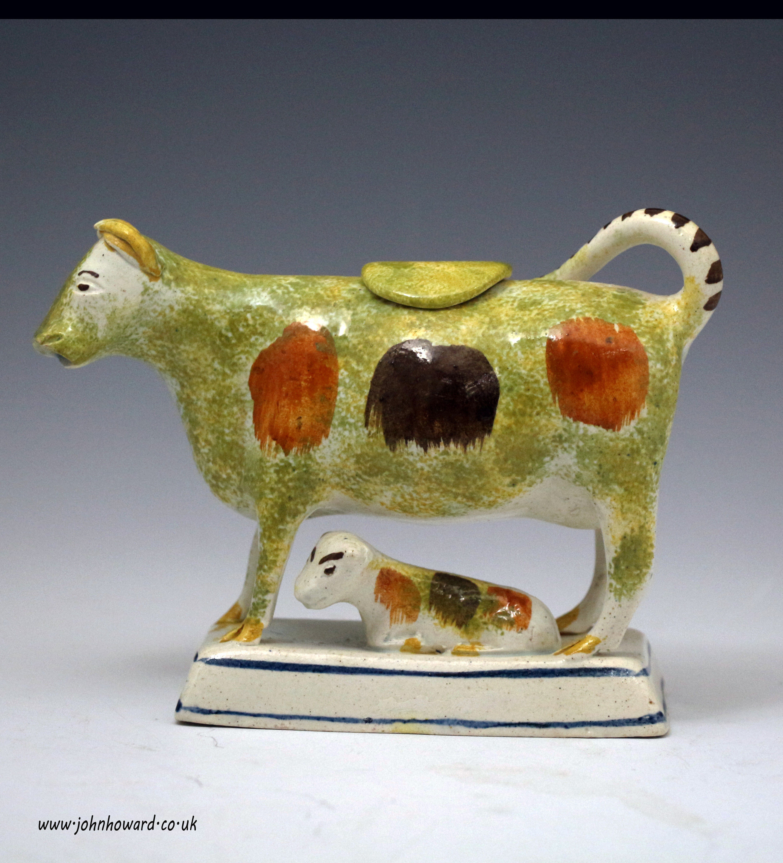 English pottery cow creamer with figure of calf circa 1800