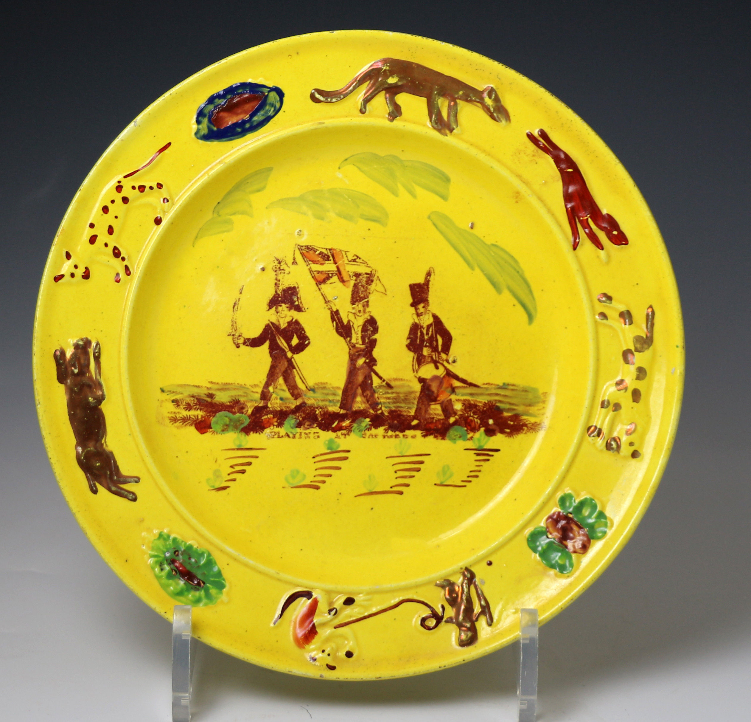 Antique Welsh pottery childs nursery plate in canary yellow showing children 