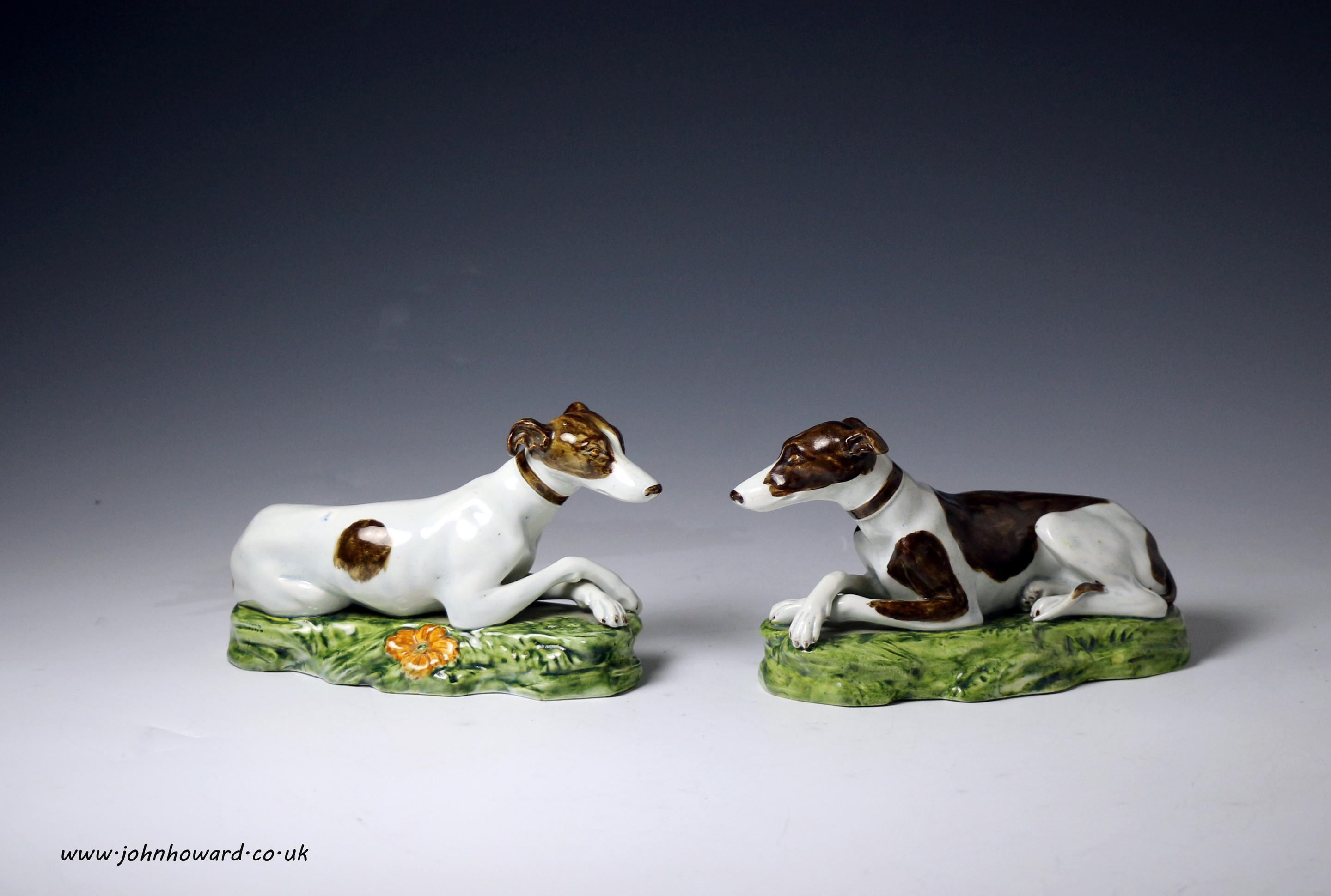 Two Staffordshire pottery pearlware figures of dogs on bases circa 1820 England