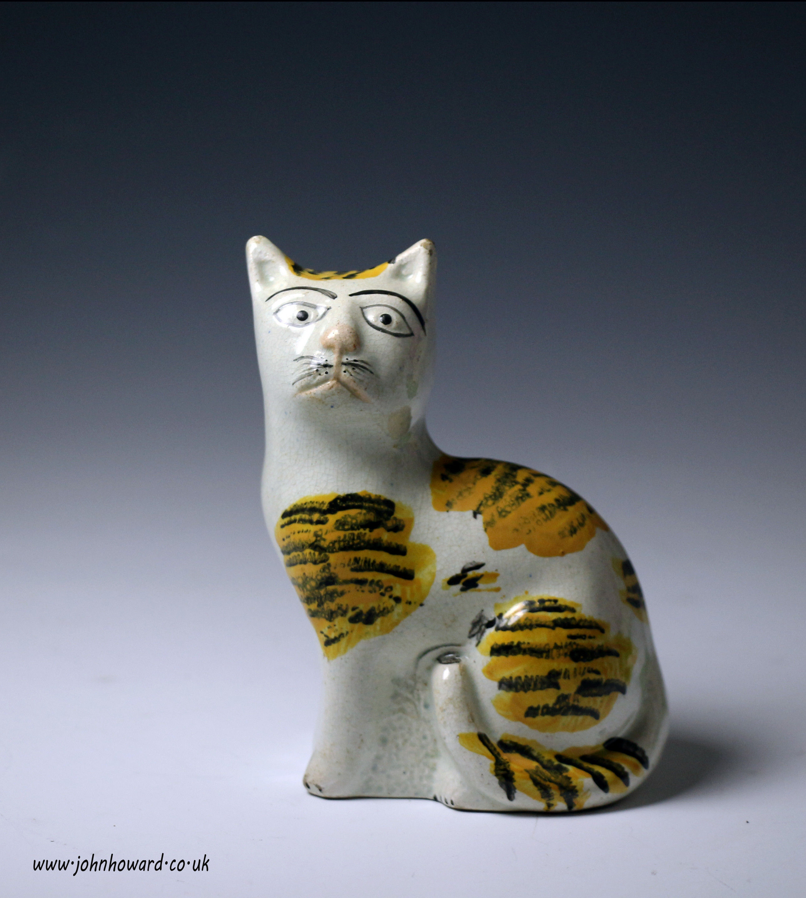 Antique English pottery figure of a naive seated cat circa 1830