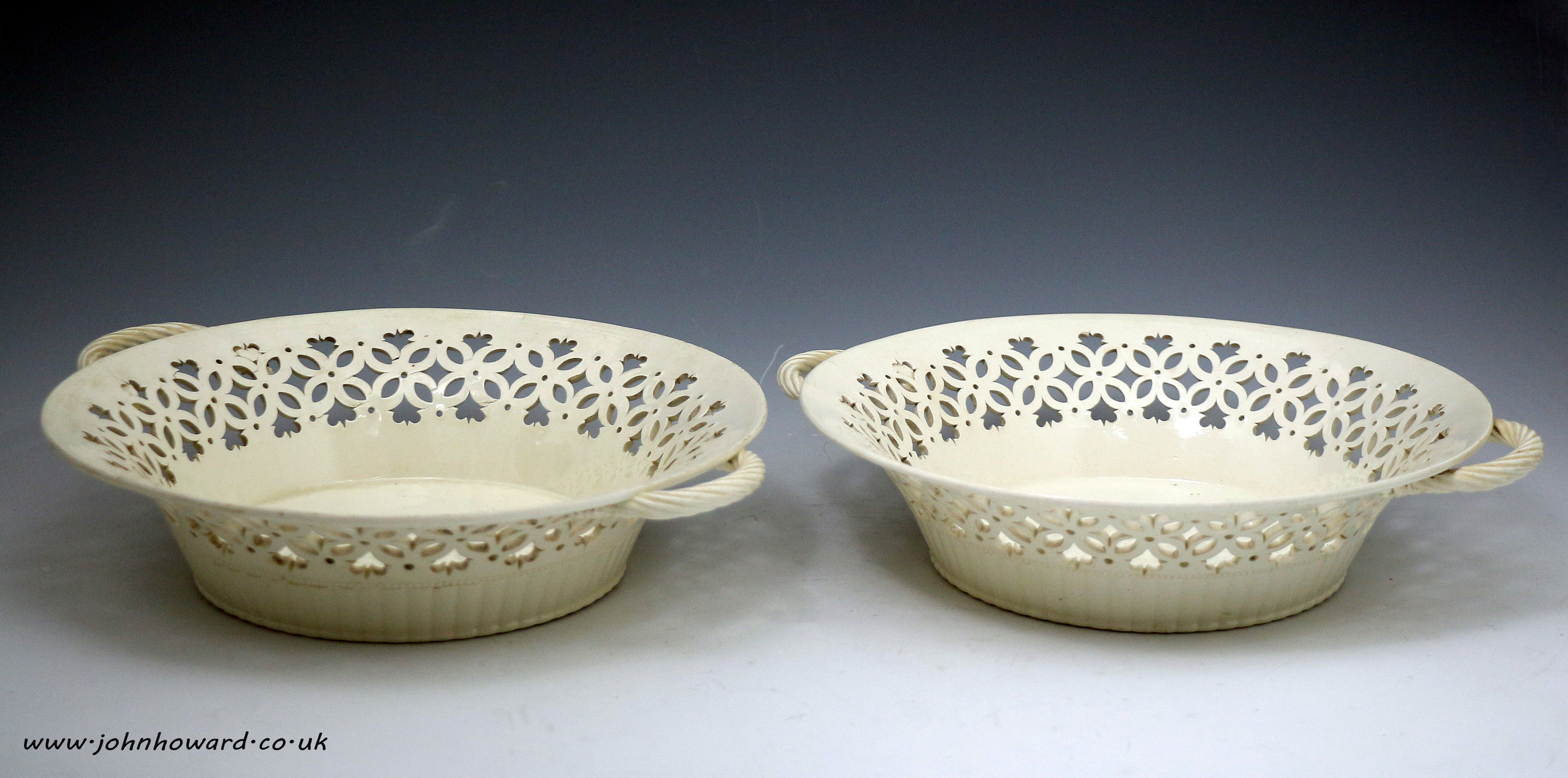 Pair of plain creamware baskets with reticulated borders, English pottery late 18th century
