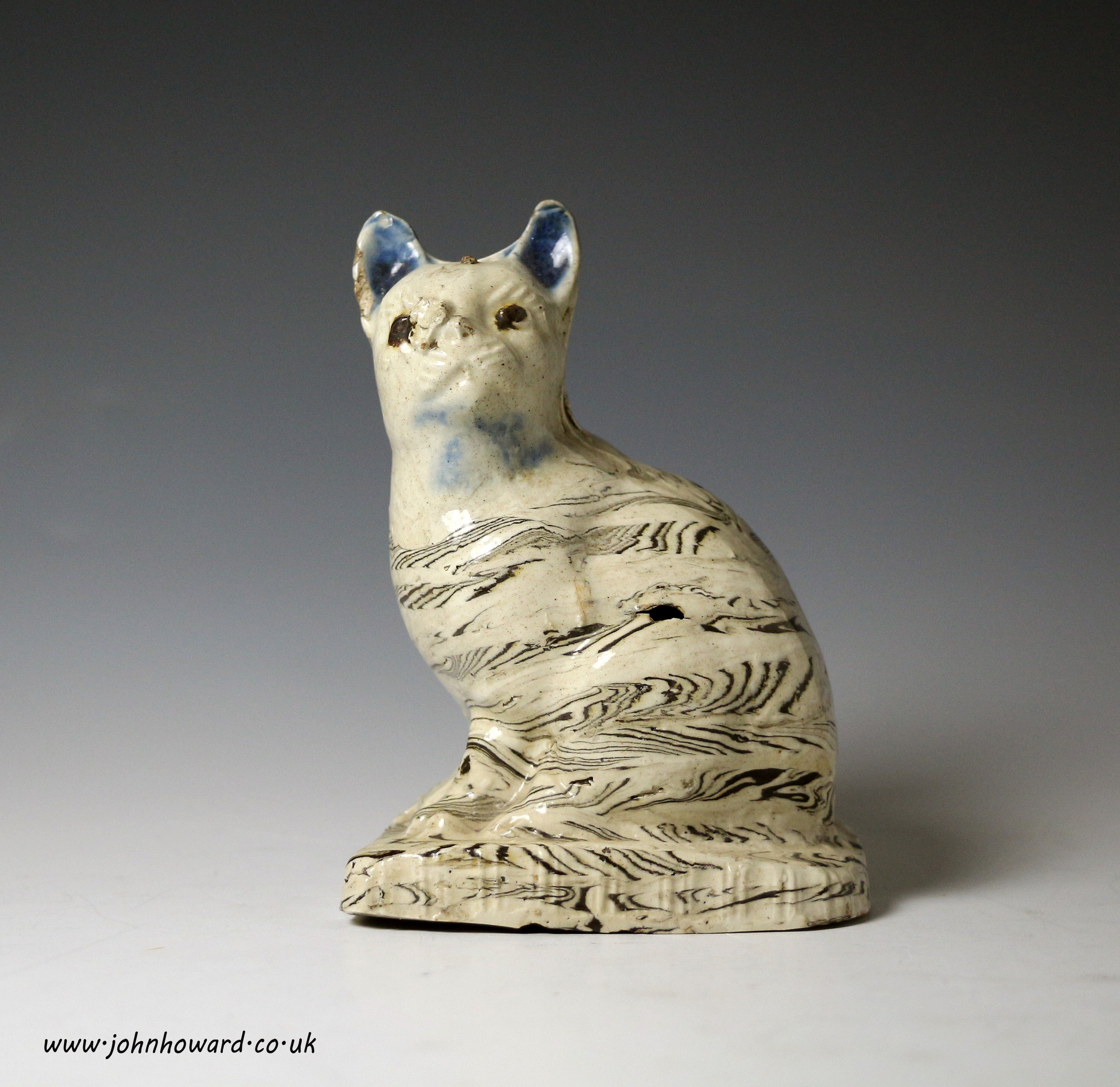 Staffordshire pottery stoneware saltglaze agate ware figure of a cat on base mid 18th century