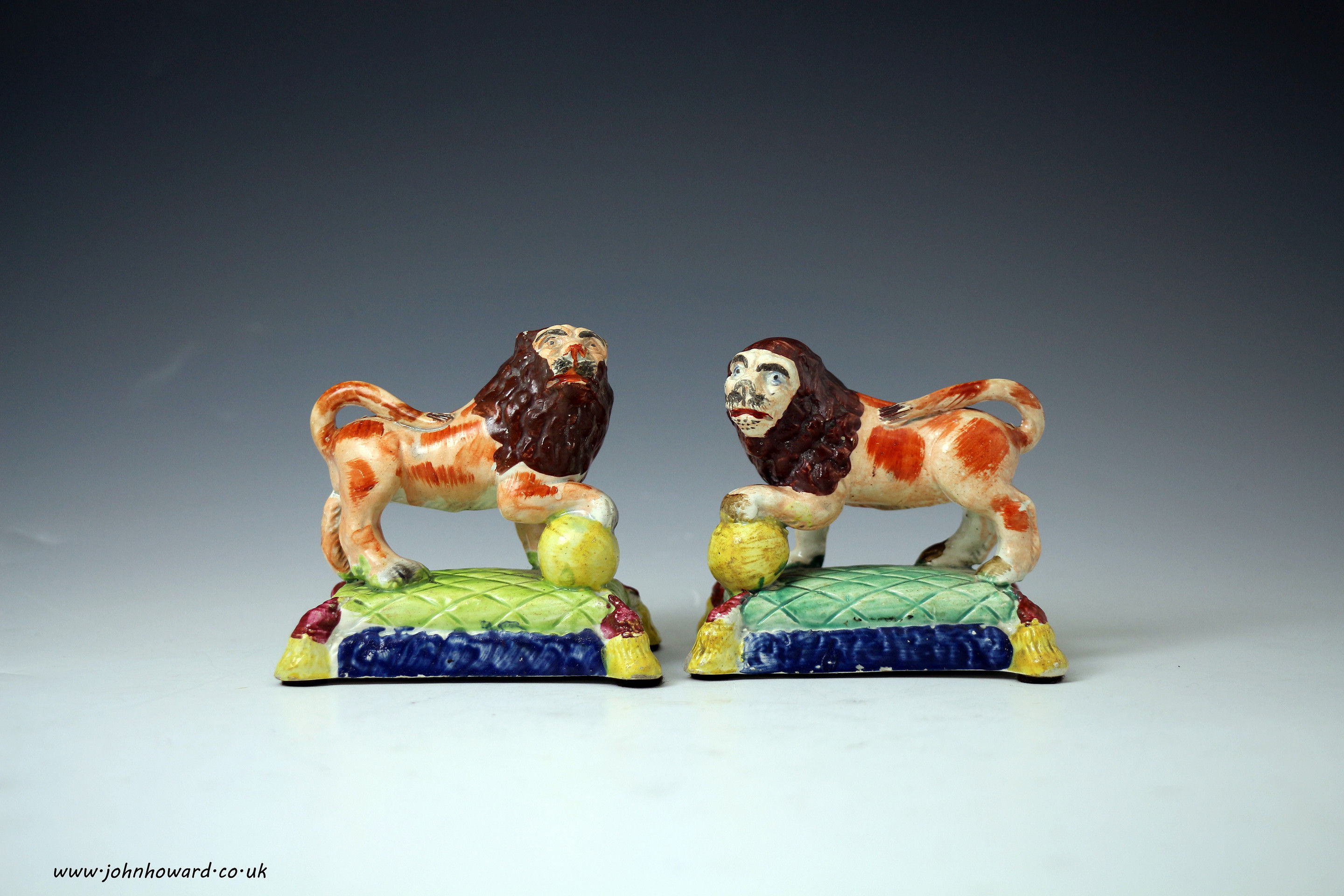 Staffordshire pottery figures of lions on bases, pearlware early 19th century