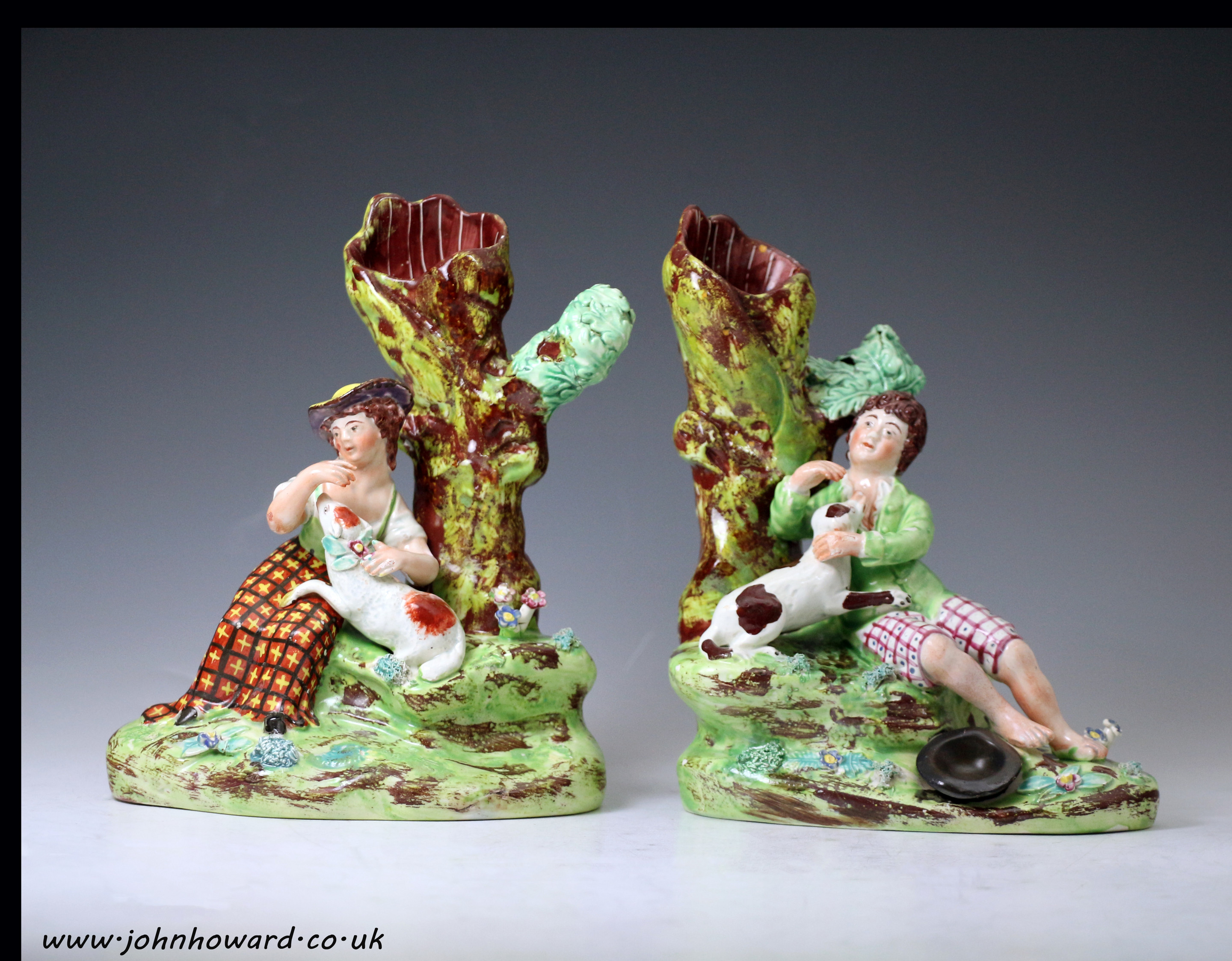 Pair of Staffordshire pottery pearlware figures of shepherd with dog and shepherdess with lamb early 19th century Engish.