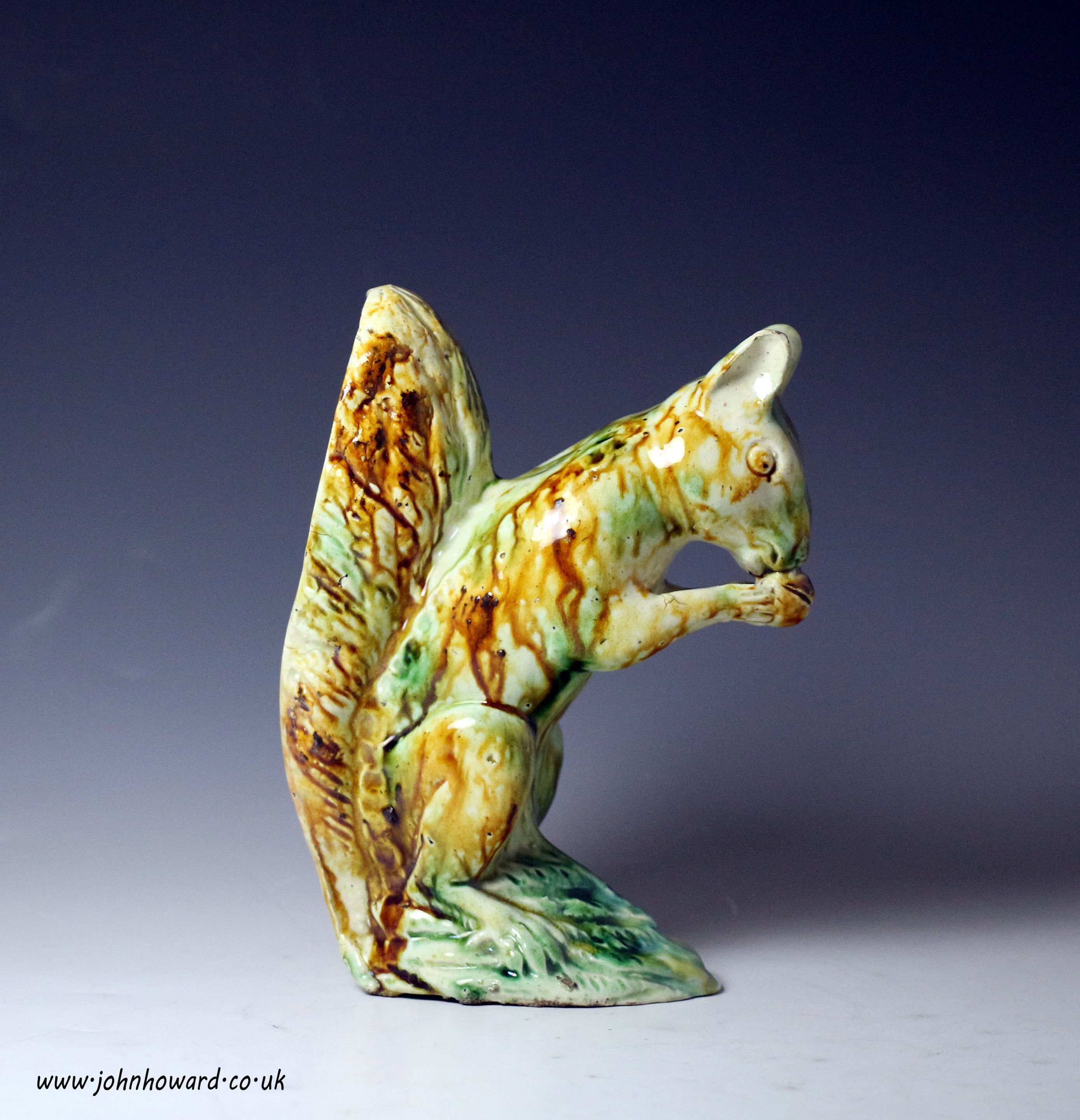 Late 18th cenury English pottery figure of seated squirrel eating a nut, Staffordshire c1785
