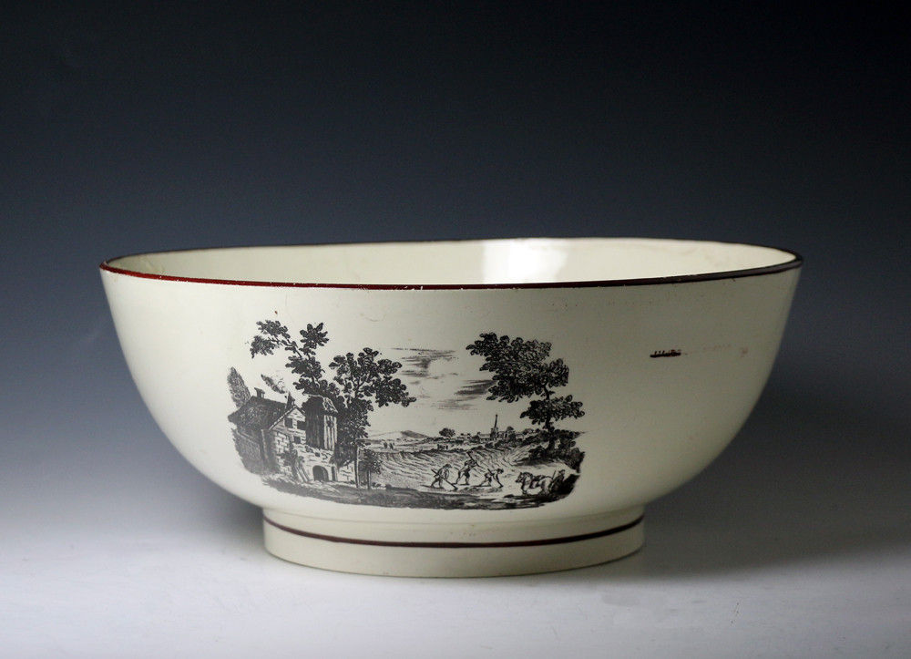 Late 18thc period large creamware  pottery bowl with underglaze transfer prints of rural scenes.