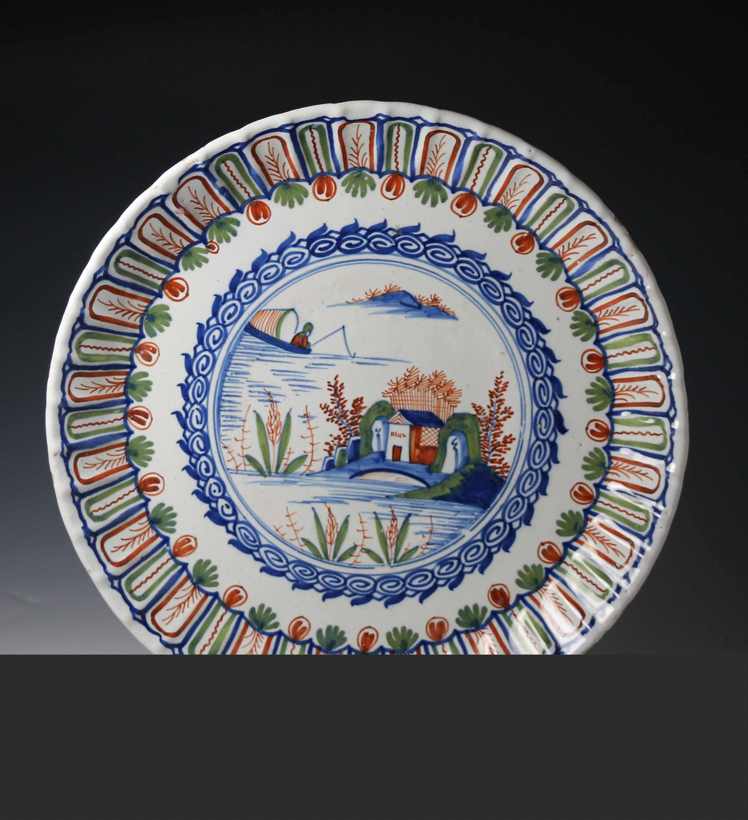 Antique English pottery polychrome  delftware decorated charger Chinoserie image early 18th century period.