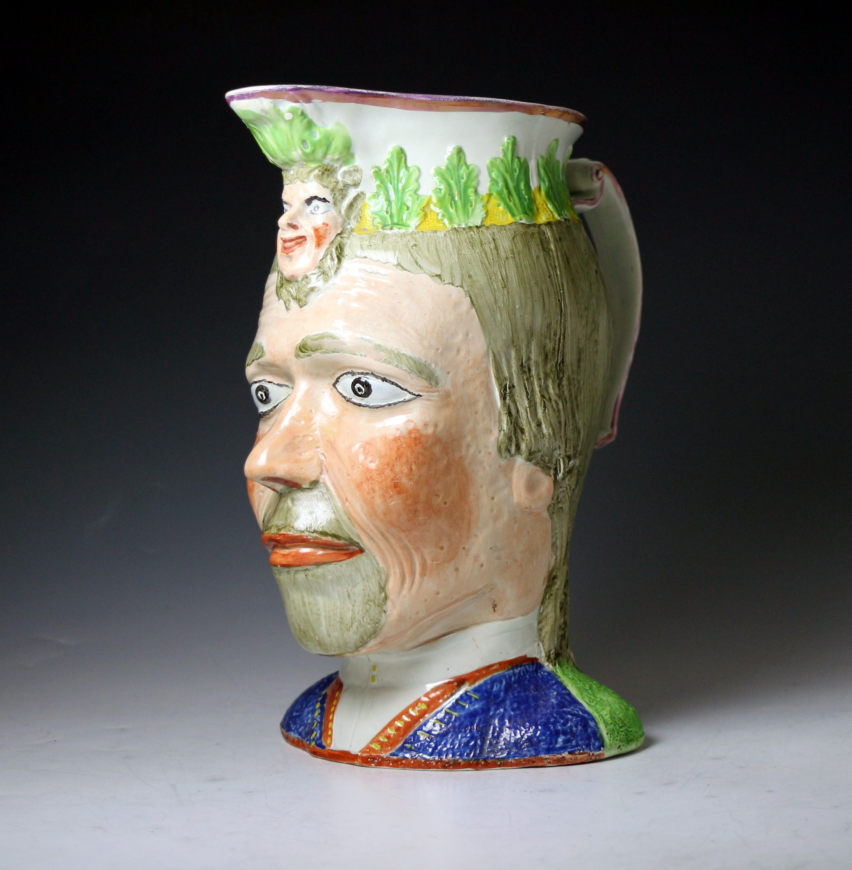 Staffordshire pottery pitcher in the form of male head with mask face spout early 19th century England