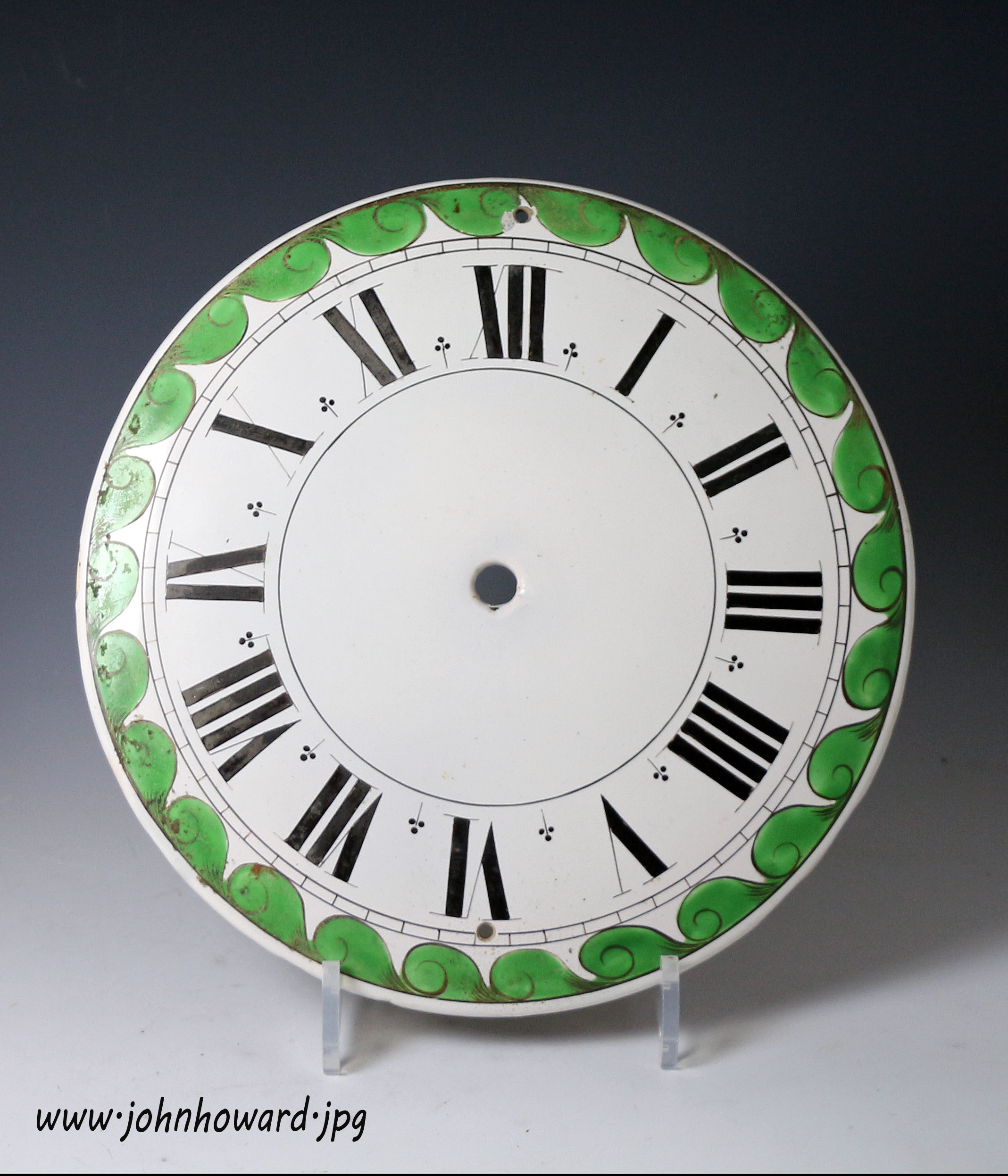 Antique English delftware clock dial with a green scrolled border late 18th century
