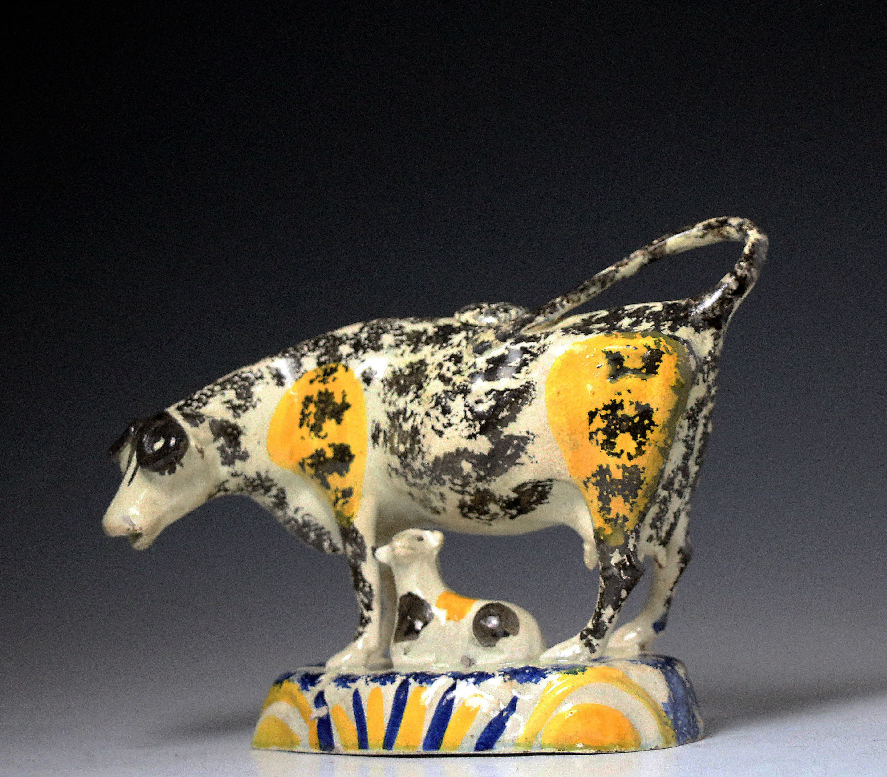 English pottery Pratt coloured cow creamer figure with calf, antique period 1810.
