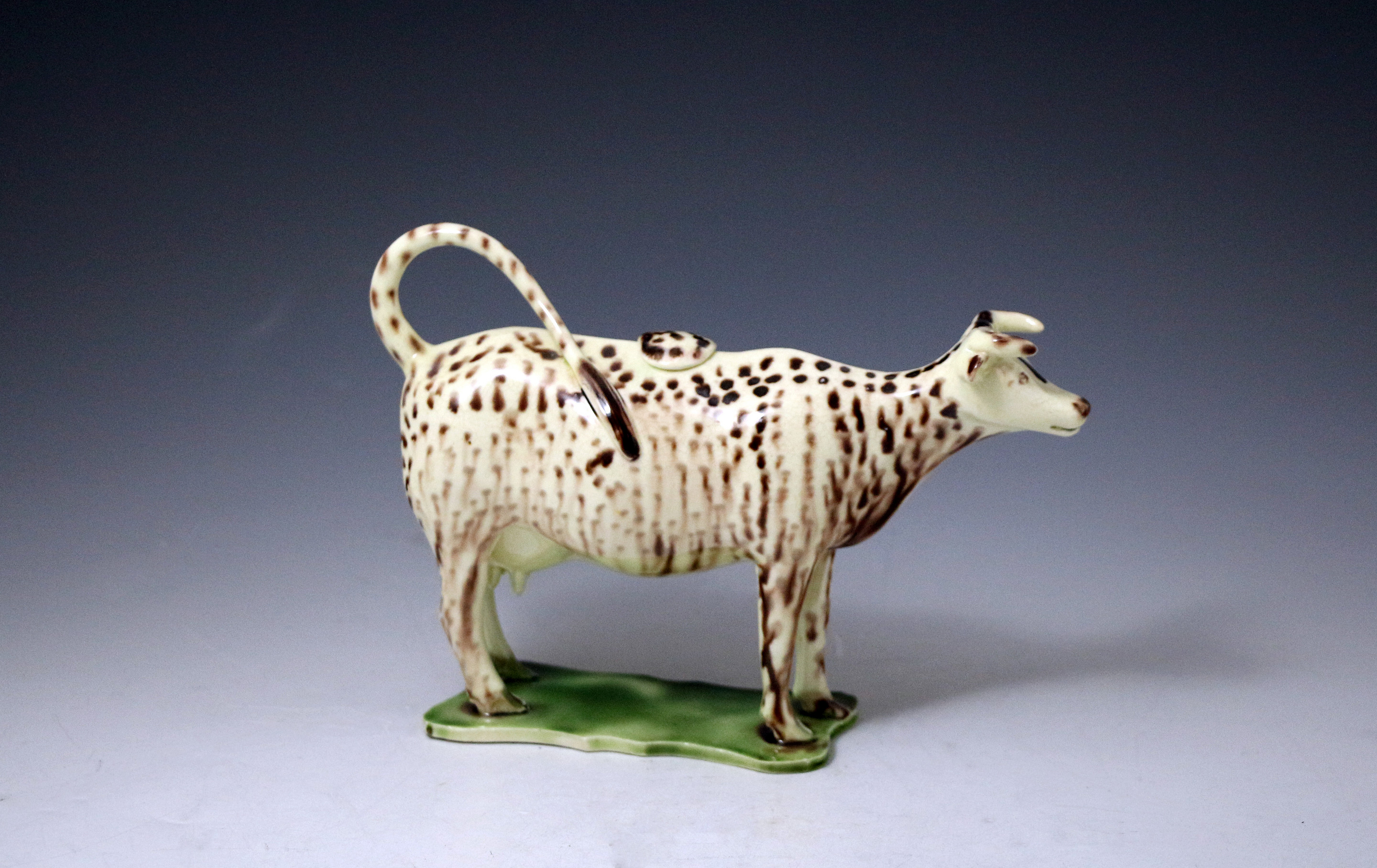  English pottery creamware bodied cow creamer figure decorated in oxide colours late 18th century antique period.