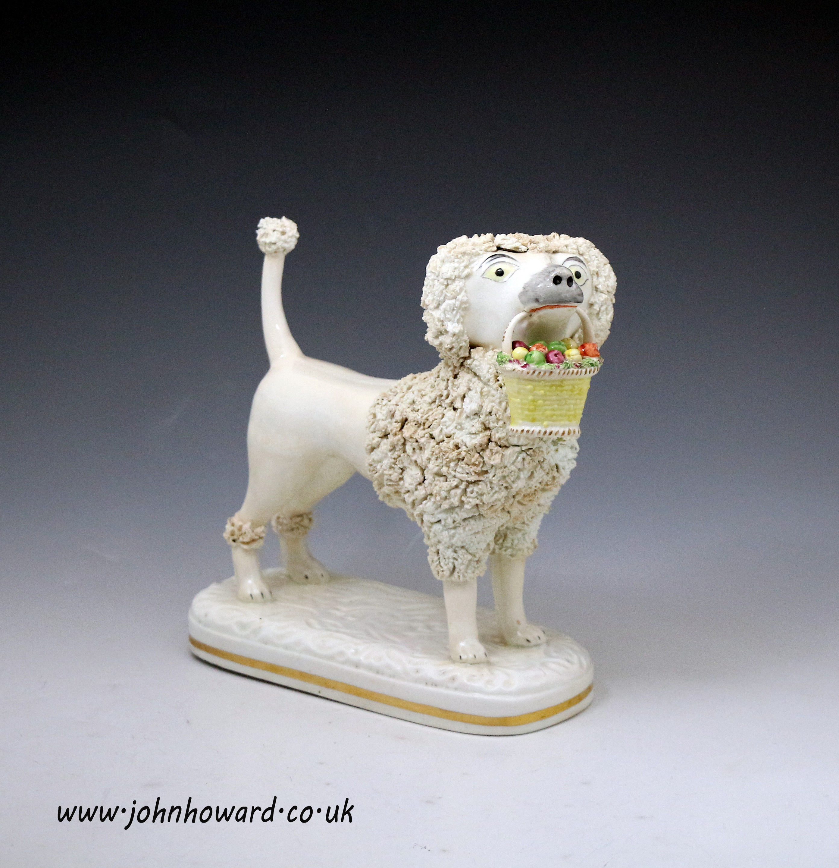 Large Staffordshire figure of a standing Poodle with basket in mouth circa 1840 English